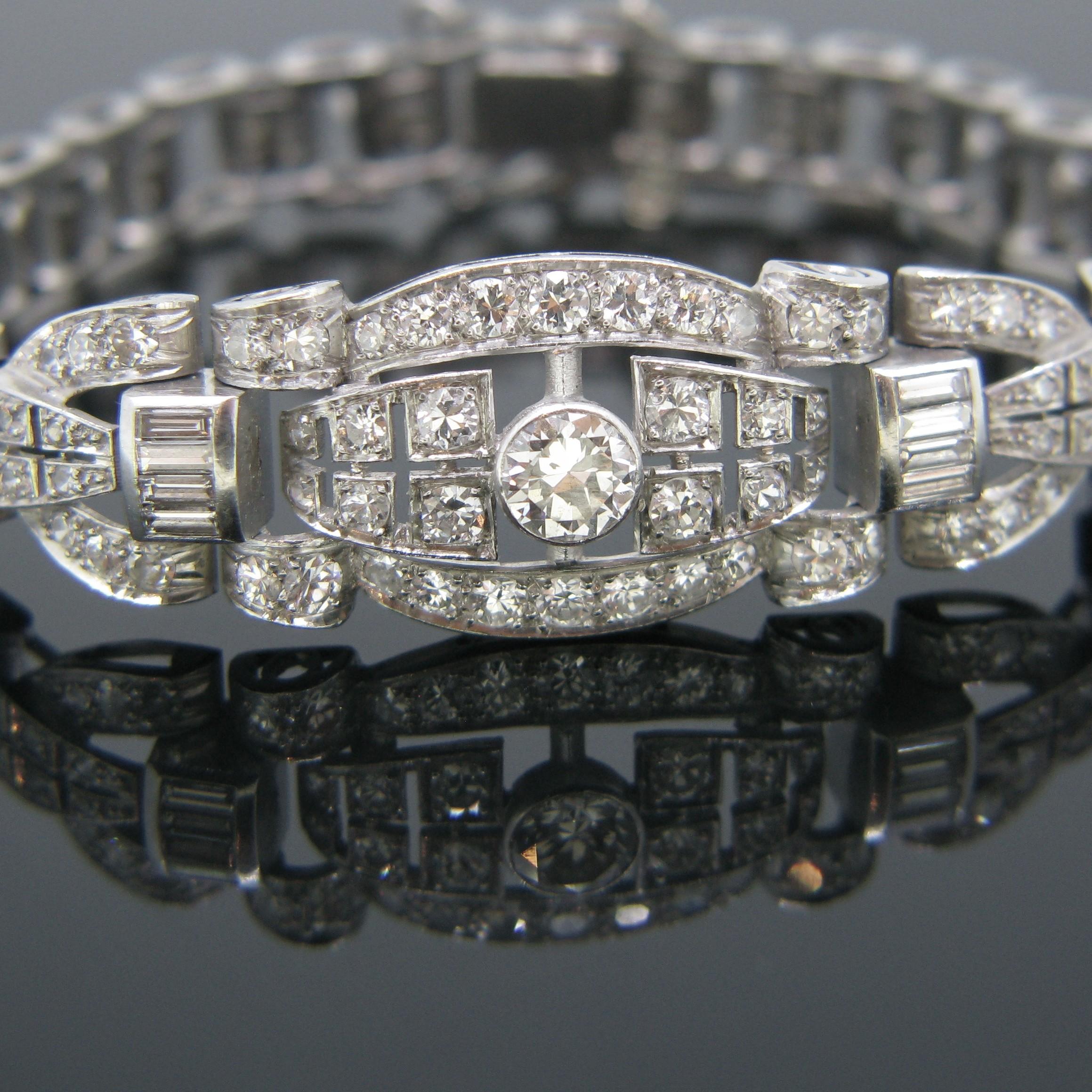 This beautiful bracelet comes directly from the Art Deco era. It is fully made in 18kt white gold and platinum. It features 118 diamonds – 110 are old European cut and 8 are baguettes. The centre diamond weighs 0.60ct approximately and the total