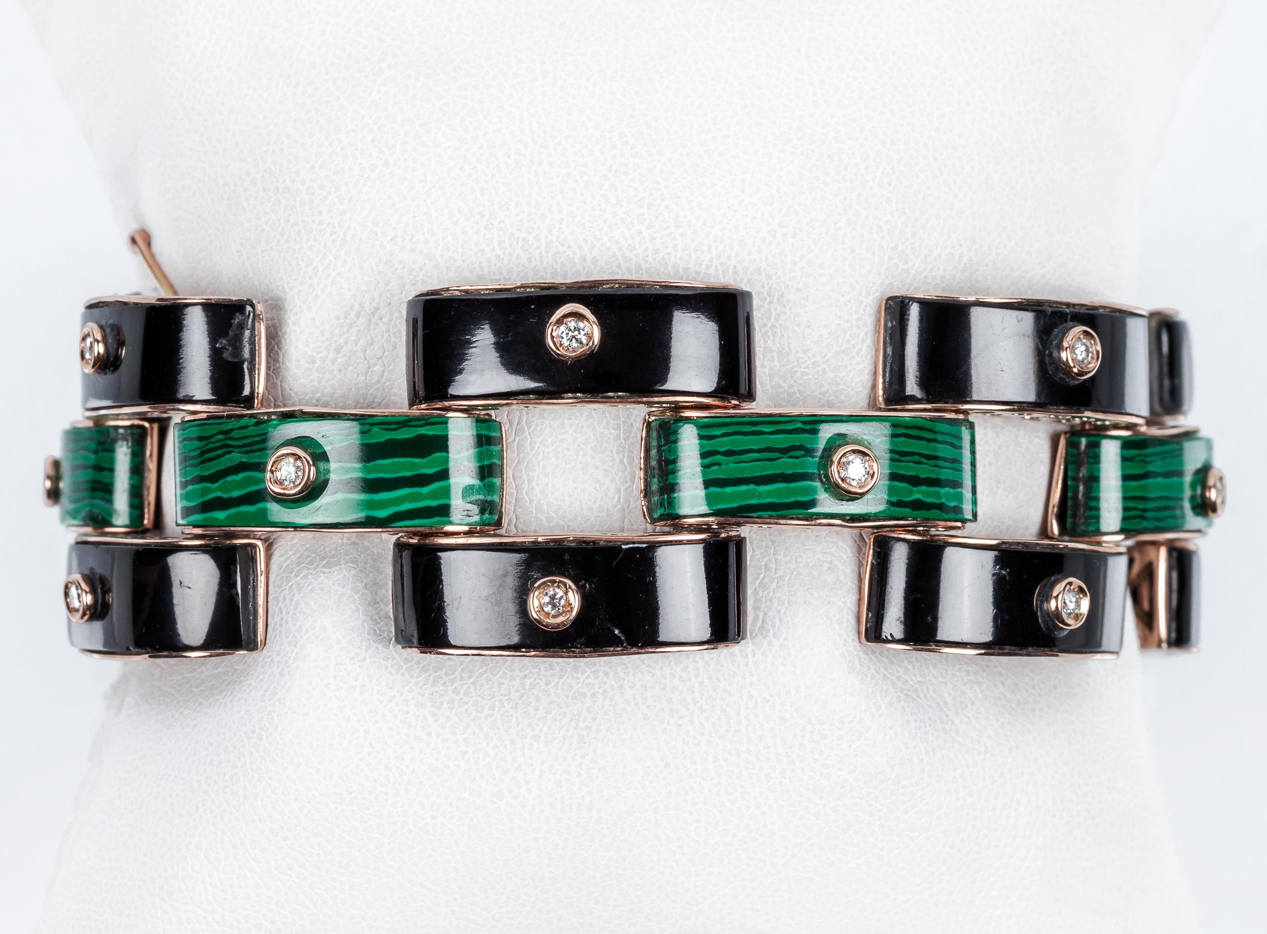Art Deco Deco bracelet, made up of articulated links, tank tecnique in black onyx and malachite with a clean, white brilliant cut diamond.
Solid 9K rose gold setting 
Diamonds 18 bts: 0.72 ct approx. H color, VS purity
Security chain.