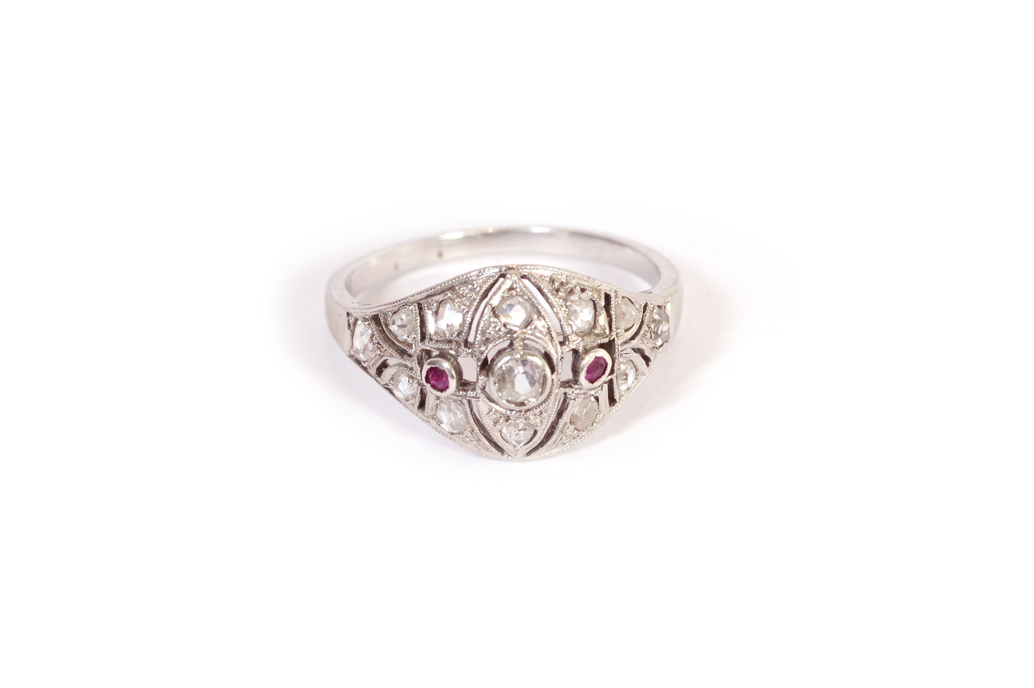 Art Deco diamonds ruby ring in 18-karat white gold. Ring set with 13 rose-cut diamonds and two small round rubies. The central diamond is an old cut and weighs approximately 0.05 carats. The structure of the ring is openwork. Art Deco ring, circa