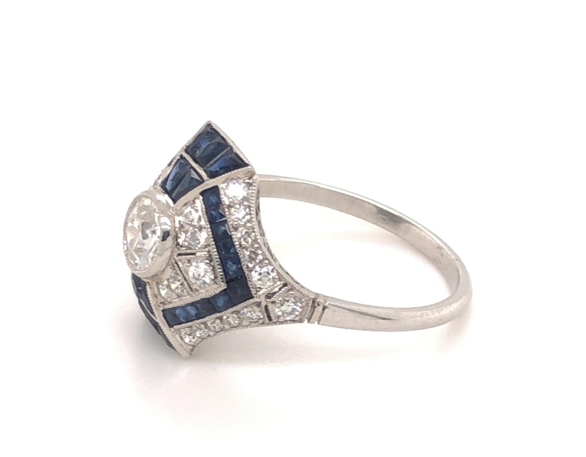 This is a beautiful art deco style ring set with an amazing setting. The ring is set with an old mine cut in the center .48 carats I Color VS-2 clarity. In addition there are 22 diamonds round diamonds I Vs-2 clarity. The 32 natural sapphires are