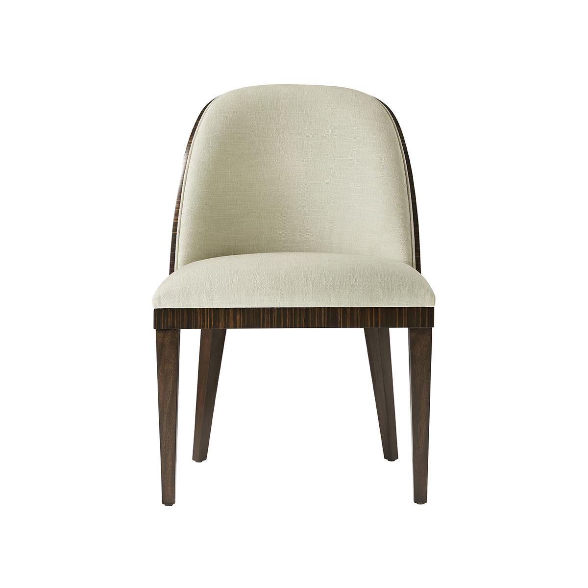 With a curved upholstered backrest and cushion seat. The reverse in a crafted exotic finish atop elegant and simple square tapered legs.

Dimensions: 22