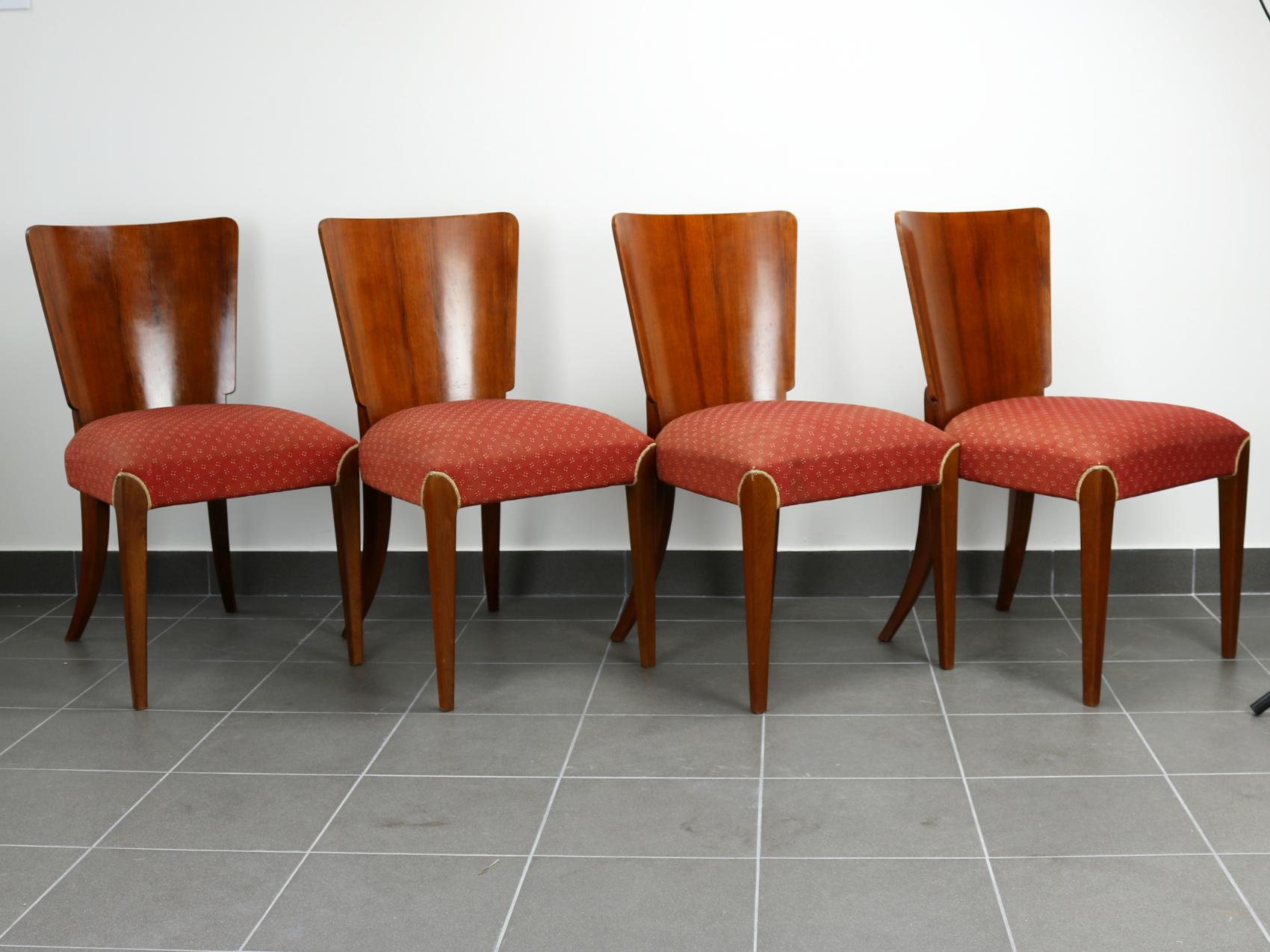 Art Deco dining chairs H214 were designed by Jindrich Halabala and manufactured in Czechoslovakia, having a beech wood frame, walnut veneer backrests, spring seats and original upholstery.