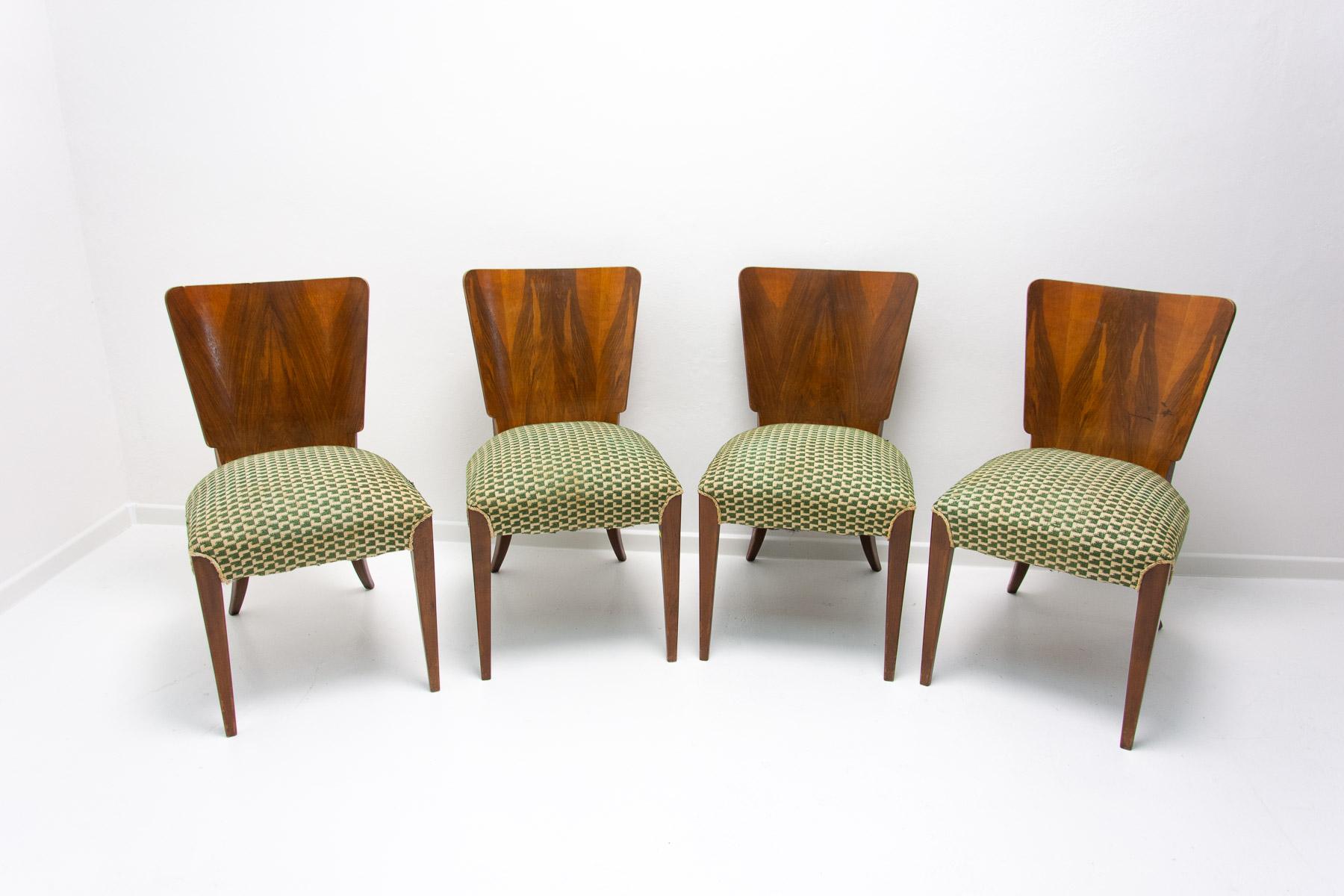 Set of four dining chairs, catalog number H-214, designed by Jindrich Halabala in the 1930´s, manufactured in ÚP Závody in the 1950´s. It features walnut veneer and original upholstery. The chairs are in very good Vintage condition, showing signs of