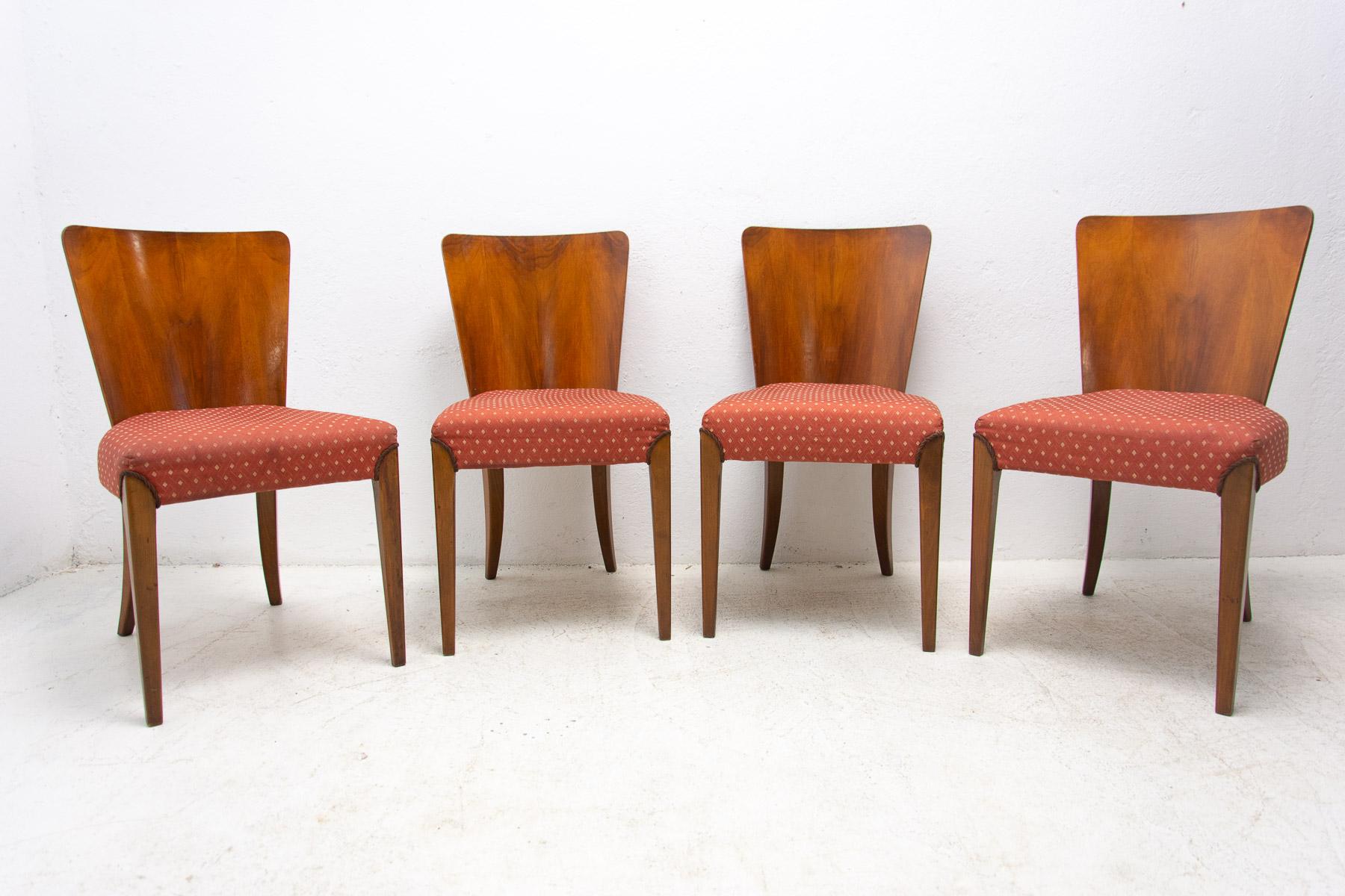 Set of four dining chairs, catalog number H-214, designed by Jindrich Halabala in the 1930´s, manufactured in ÚP Závody in the 1950´s. It features walnut veneer and original upholstery. The chairs are in very good Vintage condition. Price is for the