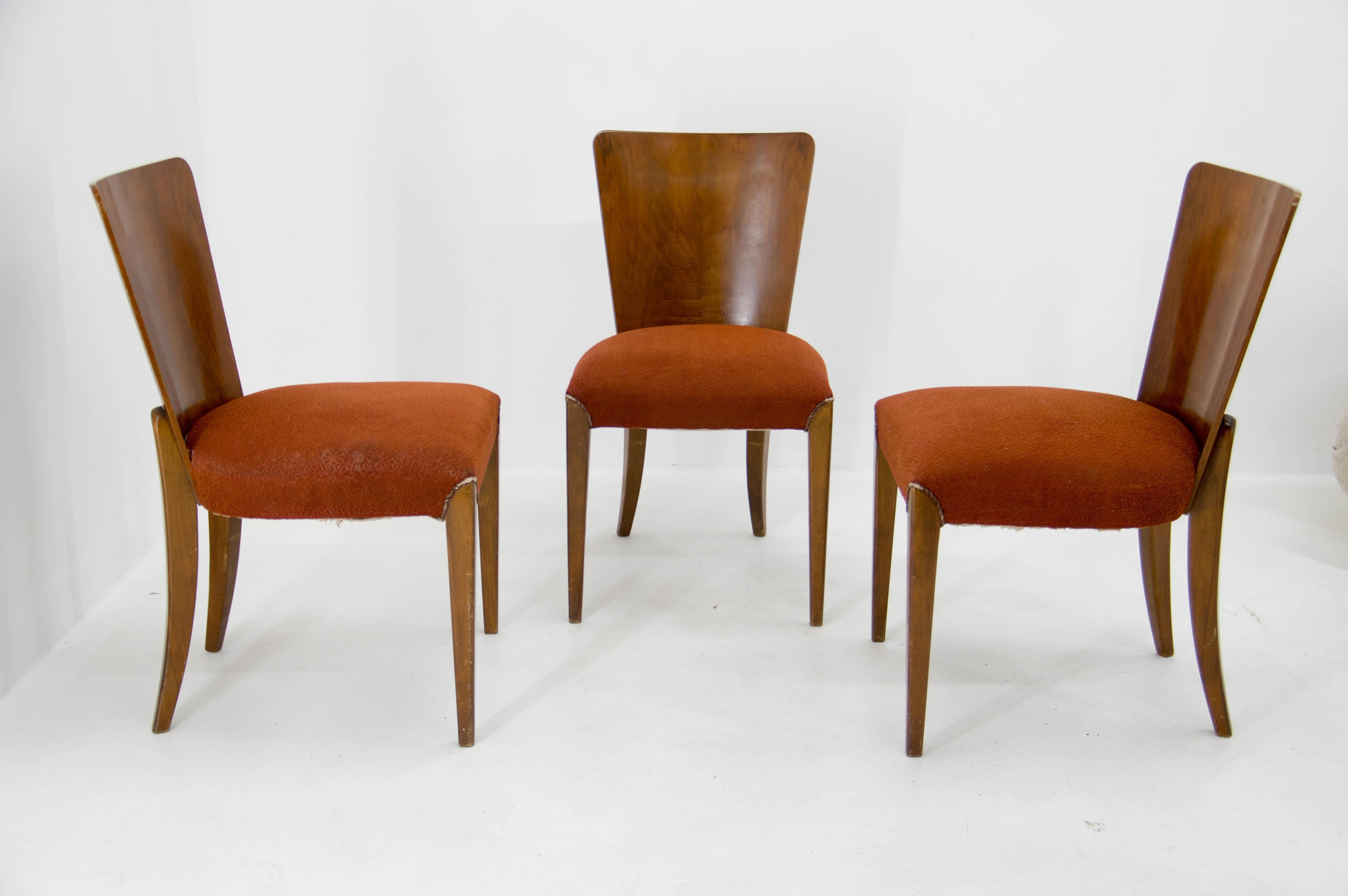 Set of three dining chairs, catalog number H-214, designed by Jindrich Halabala in the 1930s, manufactured in ÚP Závody in the 1950s. It features walnut veneer and original upholstery. The chairs are in good original condition. Upholstery has minor