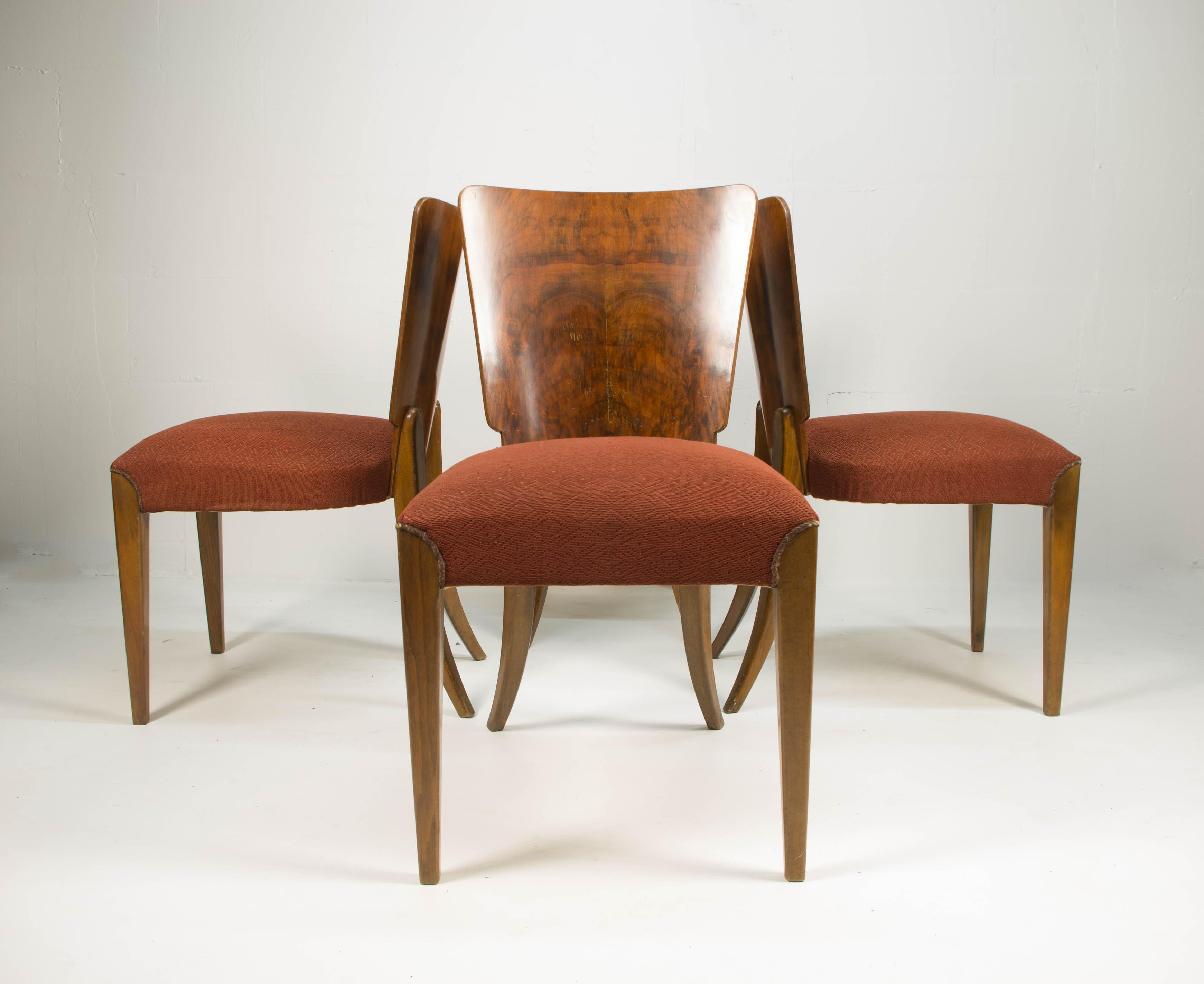 Set of four dining chairs, catalog number H-214, designed by Jindrich Halabala in the 1930s, manufactured in ÚP Závody in the 1950s. It features walnut veneer and original upholstery. The chairs are in very good original condition. The wooden parts