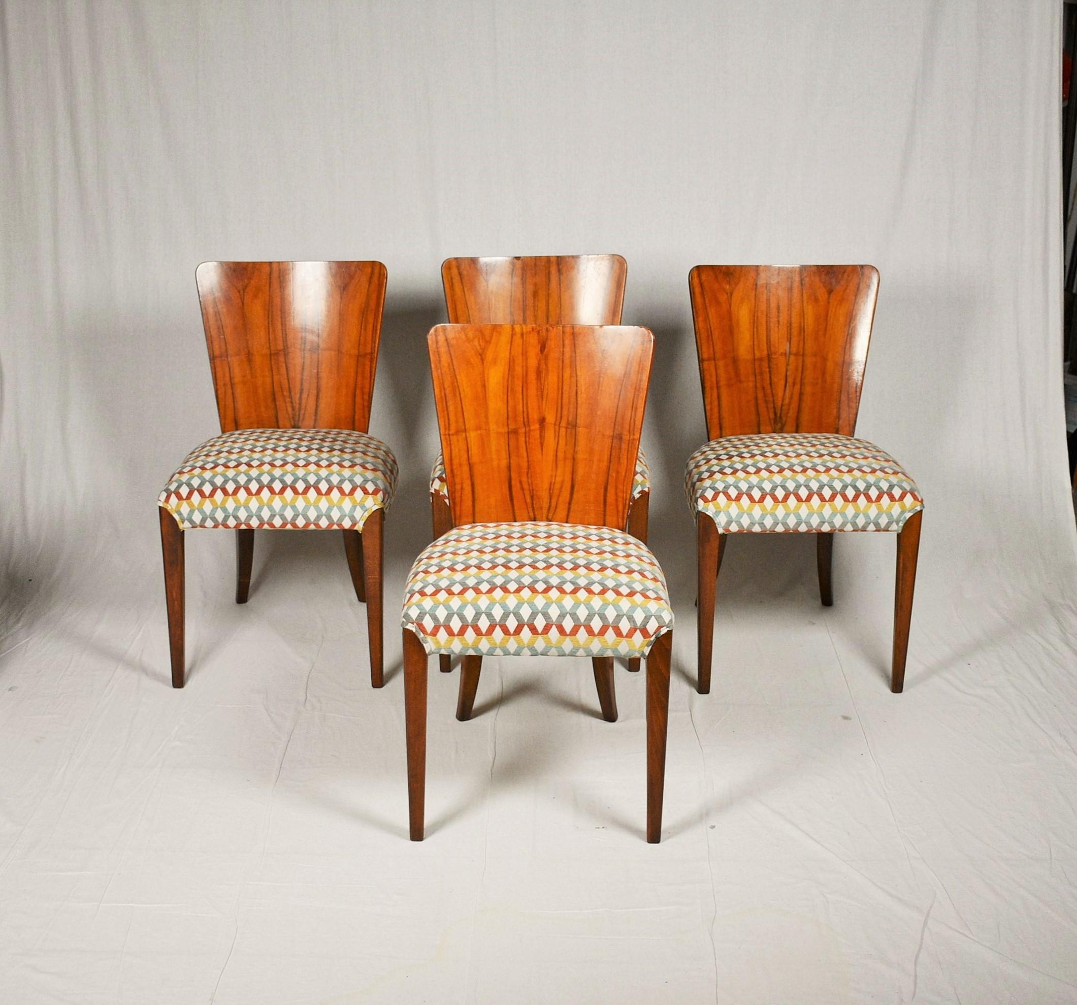 Set of four dining chairs, catalog number H-214, designed by Jindrich Halabala in the 1930s, manufactured in ÚP Závody in the 1950s. It features walnut veneer and new upholstery. The chairs are in good original condition. The wooden parts were