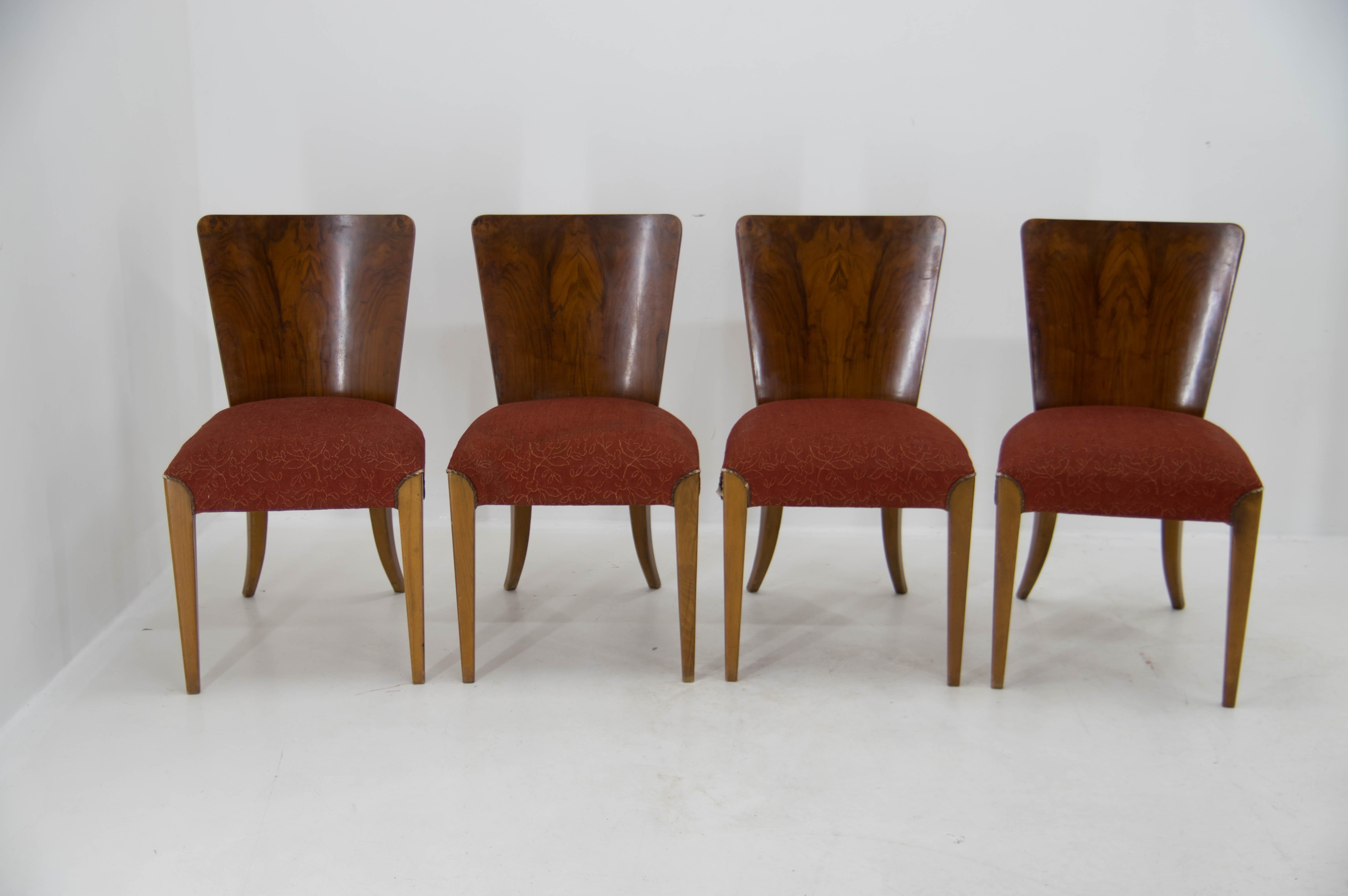 Set of four dining chairs, catalog number H-214, designed by Jindrich Halabala in the 1930s, manufactured in ÚP Závody in the 1950s. It features walnut veneer and original upholstery. The chairs are in good original condition. Upholstery has minor