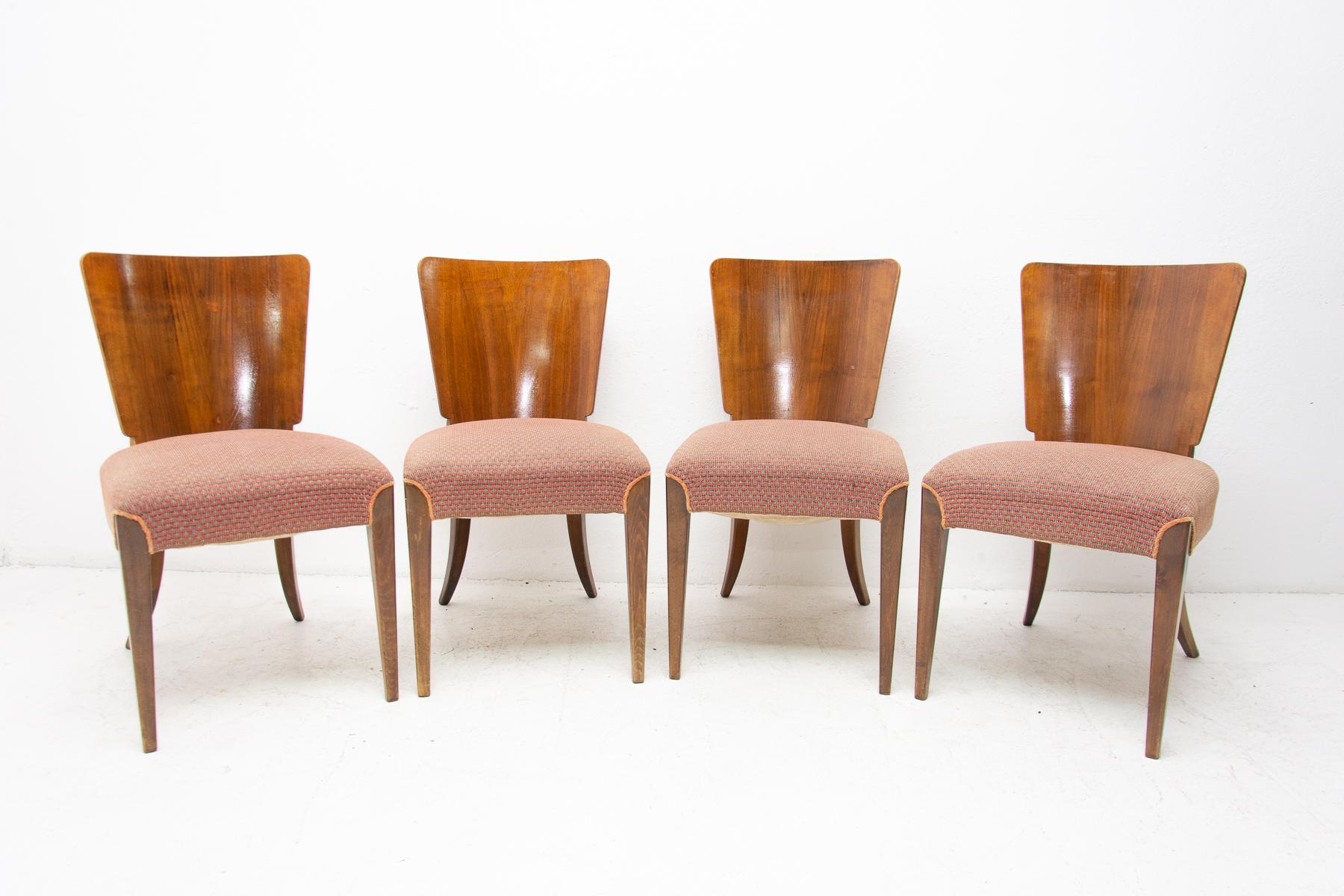 Set of four dining chairs, catalog number H-214, designed by Jindrich Halabala in the 1930s, manufactured in ÚP Závody in the 1950s. It features walnut veneer and original upholstery. The chairs are in its good original condition. Have a beautiful