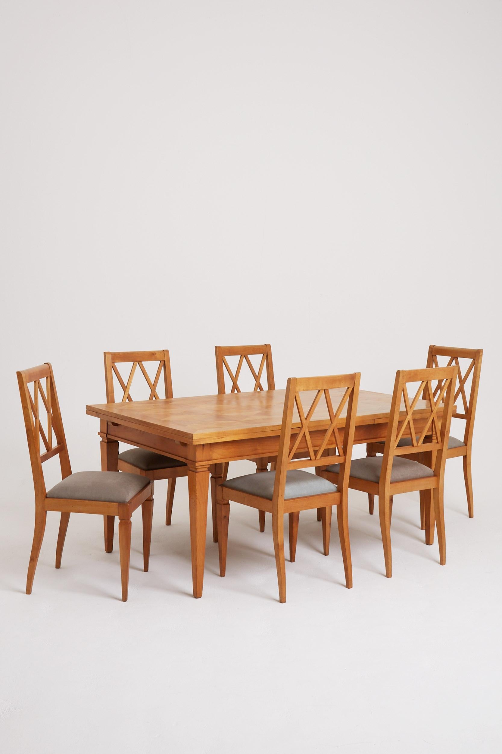 An Art Deco ash dining room set, comprising an extending dining table (with two leaves, concealed under the top) and six dining chairs.
France, Circa 1940
Dining table: 73.5 cm high by 160 cm wide by 98 cm, each leaf is 57.5 cm wide, fully