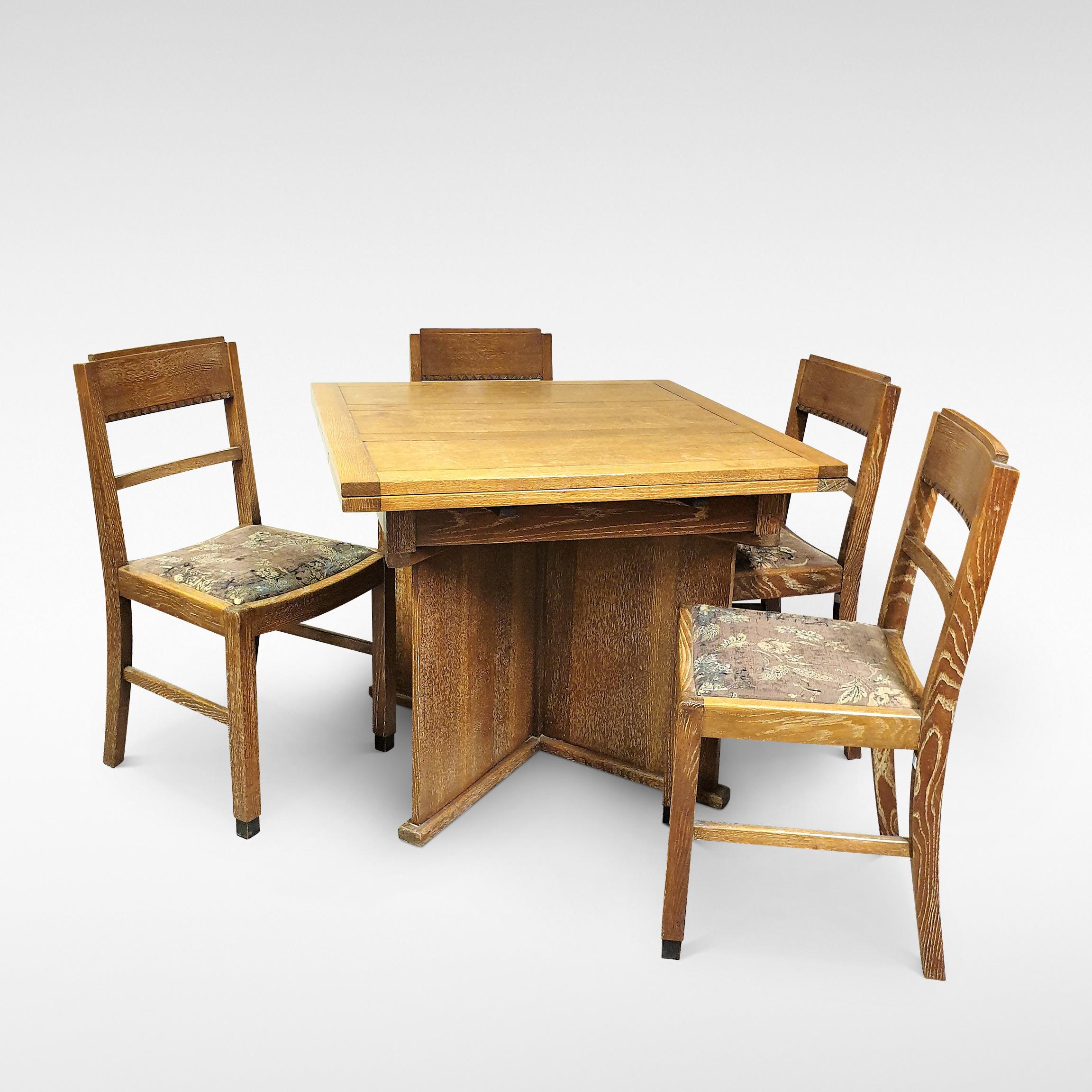 A stylish and compact extending dining table with pull out leaves and four matching chairs comprise this Art Deco Dining Suite in Limed Oak by Bowman Bros, circa 1935. Bowmans of Camden Town were noted for their trendy modernist inspired furniture.