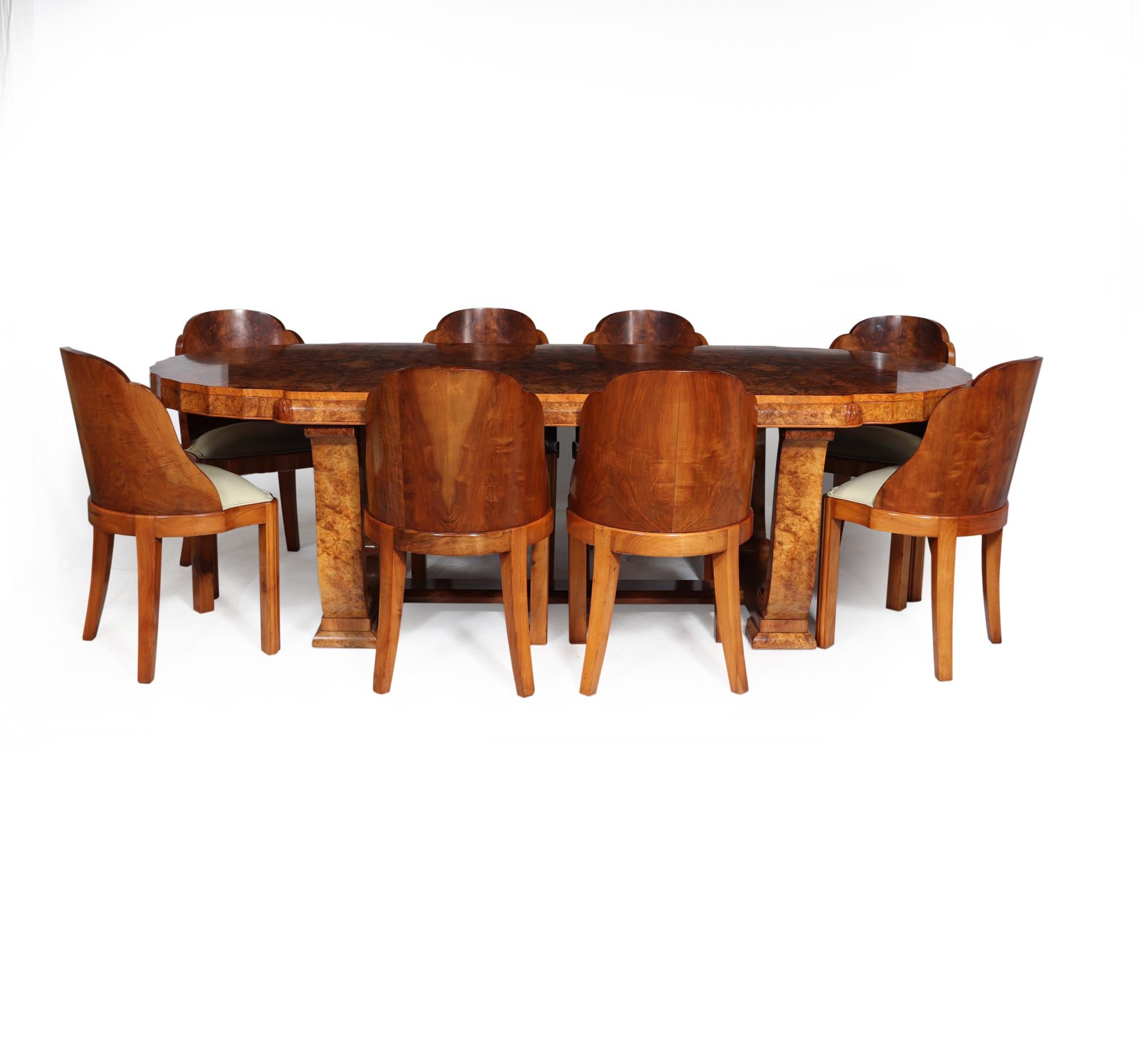 A British Art Deco Dining Suite by Hille produced in London in the 1930’s The Table has a large one piece top with highly figured burr walnut book matched veneers, the curved ends are fluted and stands on a very strong and solid base with scrolling