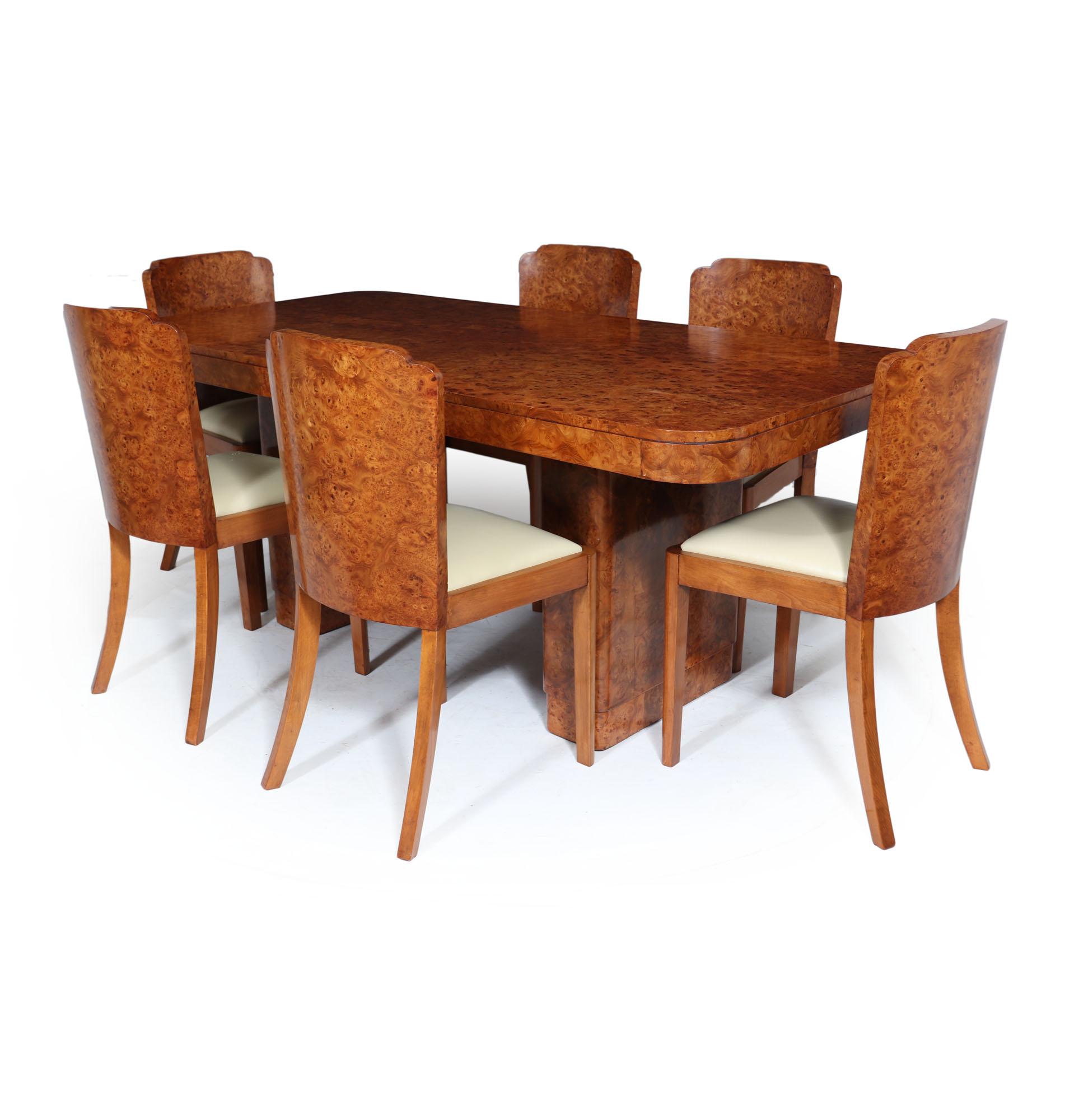 Art Deco dining table and chairs
An English Art Deco suite consisting of a twin pedestal table and set of six curved back dining chairs, produced in England in the 1930’s and having exceptional burr walnut veneers the table has two removable