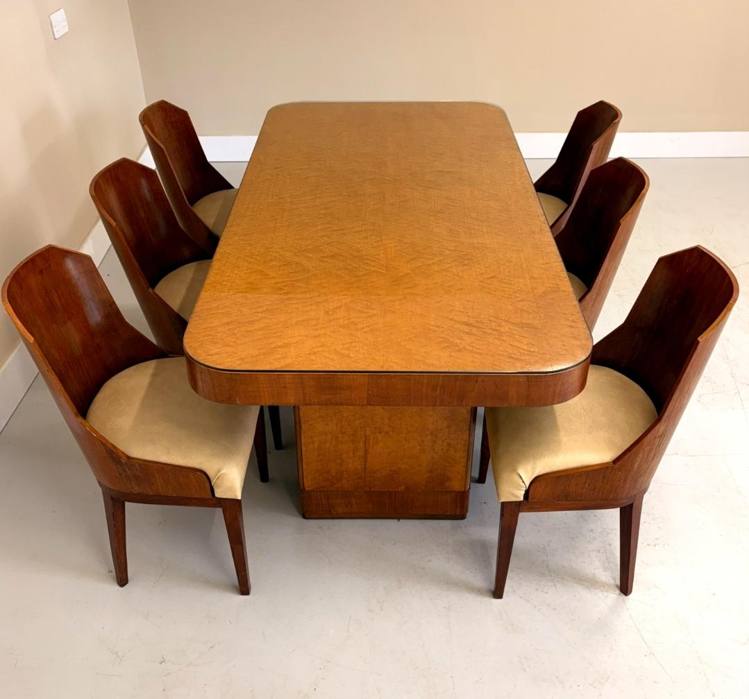 A stunning Art Deco period dining room suite, circa 1930s.
Superb quality, the suite is attributed to Harry and Lou Epstein Ltd. A Birds Eye maple dining table, with a Beautifully figured top with a protective glass cover , supplied with its