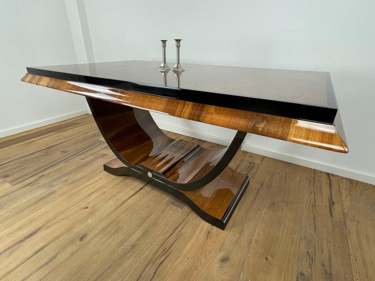 Fantastic Art Deco dining table from Paris with incredibly beautiful walnut and black accents. The entire table is painted with piano lacquer and polished by hand. An amazing table from the Art Deco metropolis!
Complete refurbish! 
Can be extended