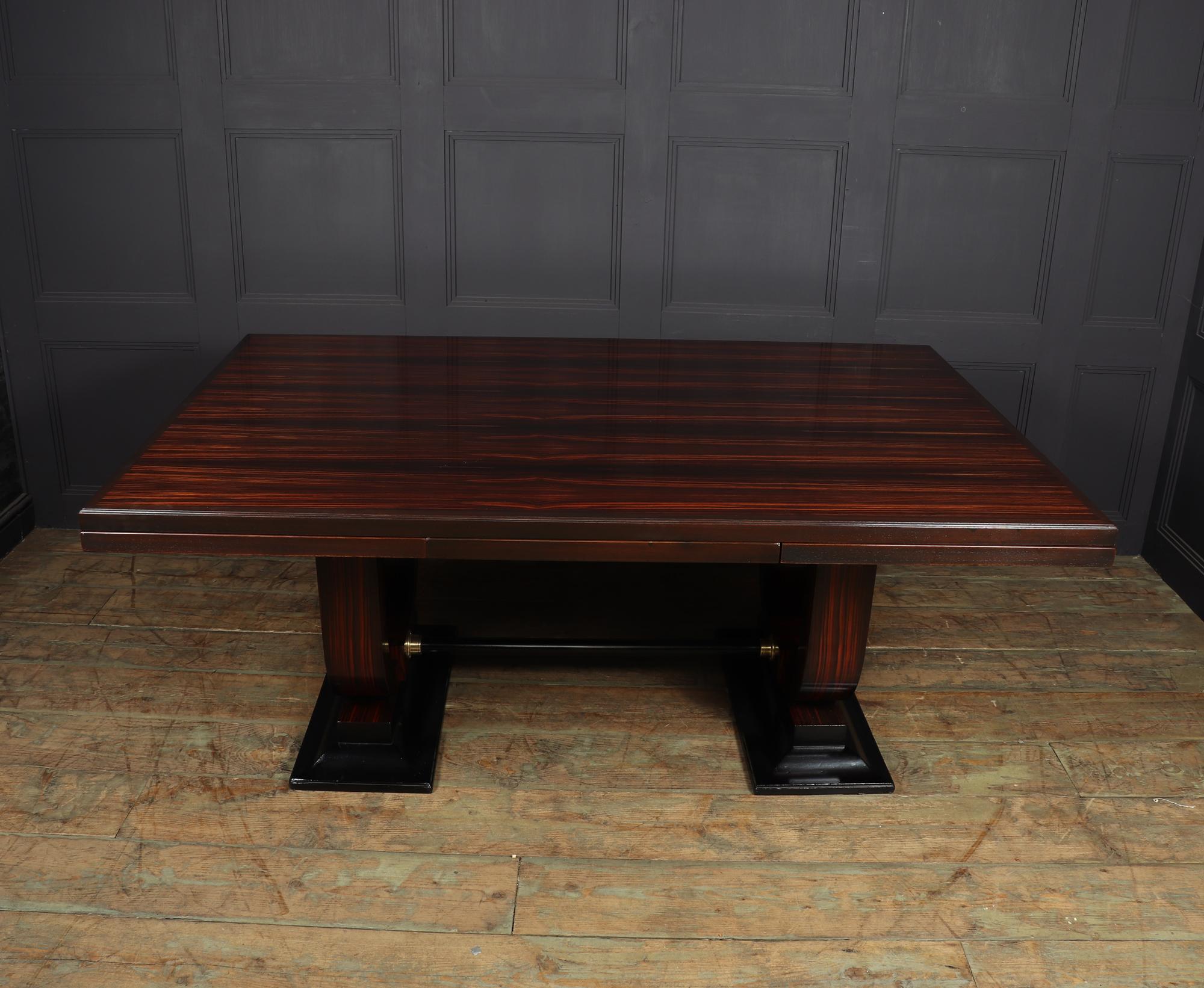 A very large dining table produced in Paris in c1925 by Leon Bernheim solid oak framed with Macassar ebony veneers, this table very much in the Manner of Emile-Jacques Ruhlmann with its double u base, extendable leaves and its exceptional