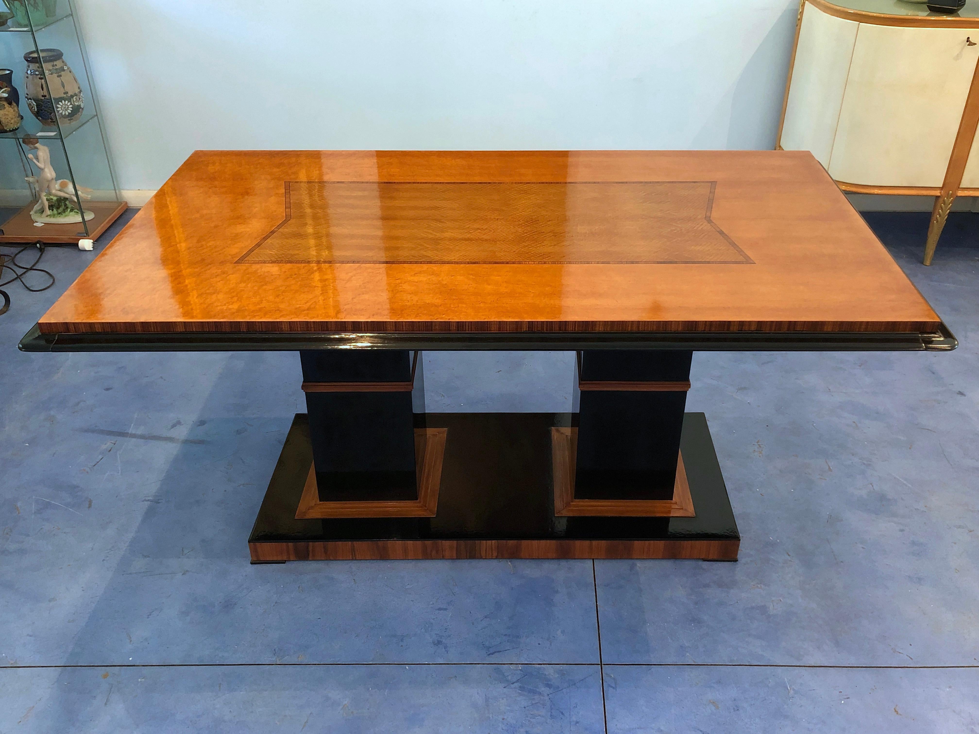 Rare Art Deco table in a rationalist style, maple top with a central decoration, black lacquered wood base and on the sides. Extendible at the ends.