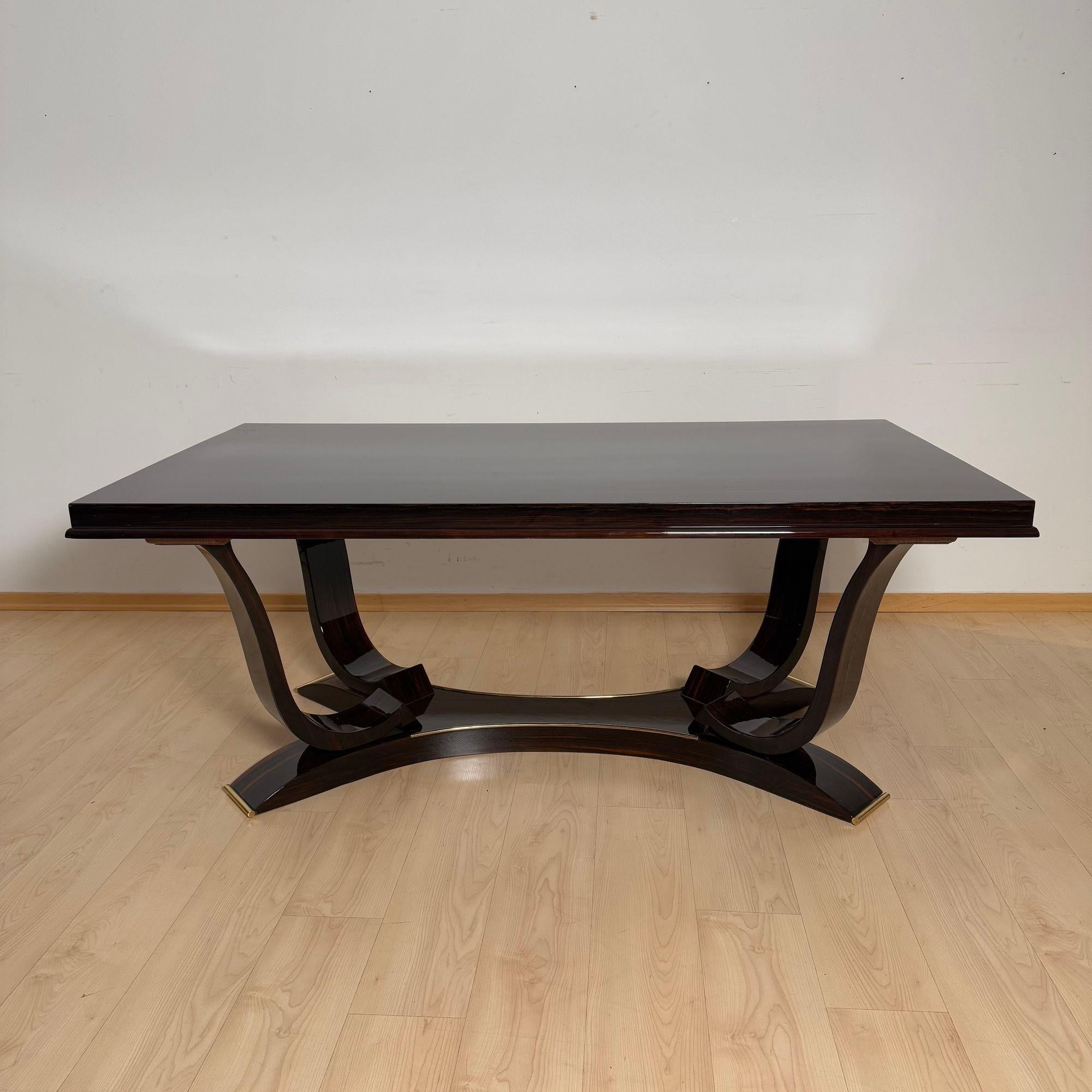 Table de salle à manger originale Art Déco avec 10 chaises en ébène de Macassar laqué et laiton, de Paris vers 1930.
La table extensible est fabriquée en placage d'ébène de Macassar, laqué et poli à un haut degré de brillance.
Très belle base avec