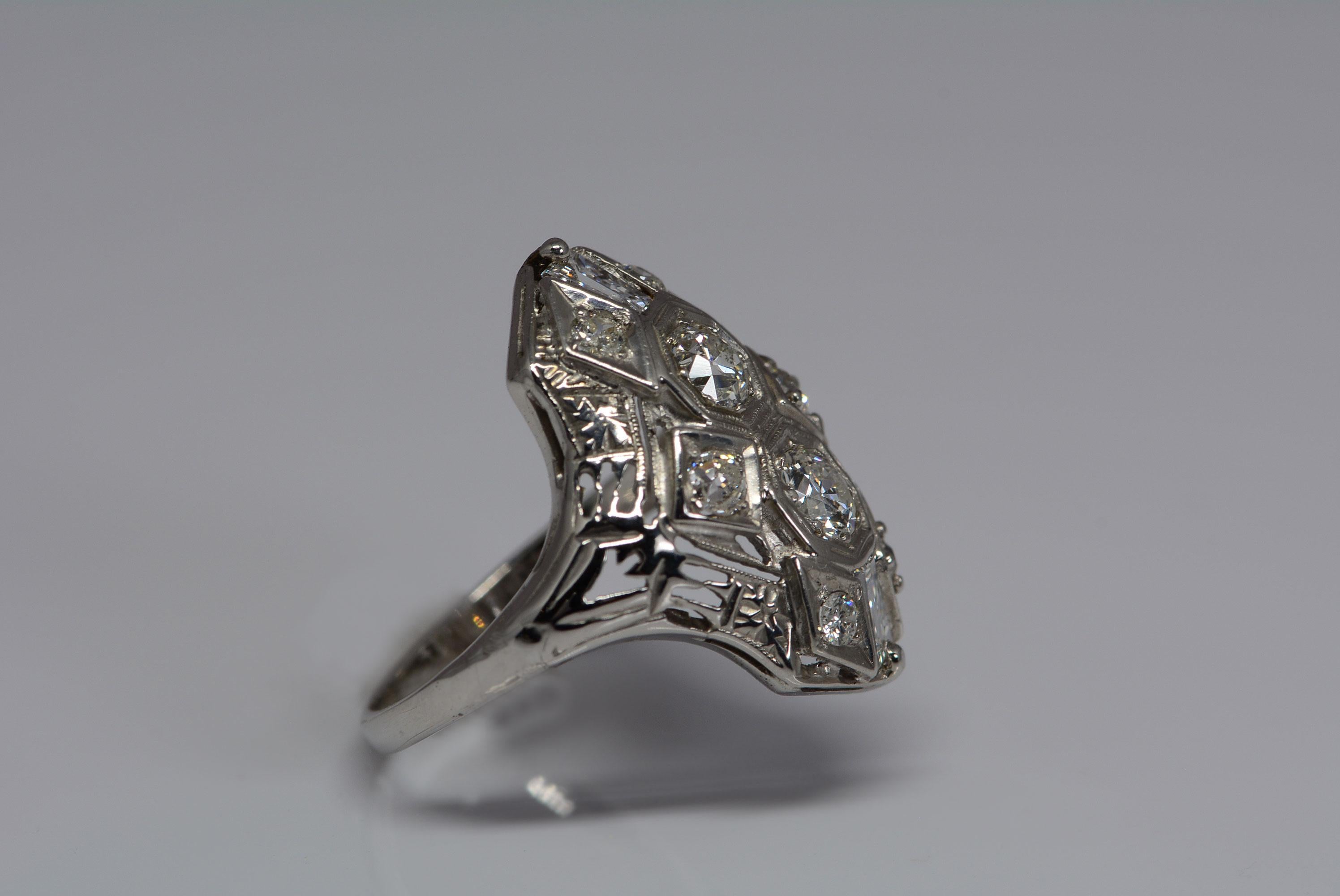 
Art deco jewellery is known for its bold lines and geometric shapes, quite a change from the delicate, and lacey edwardian era jewels that came before it but not any less stunning. 
This ring is in the art deco style and made from 14 karat white