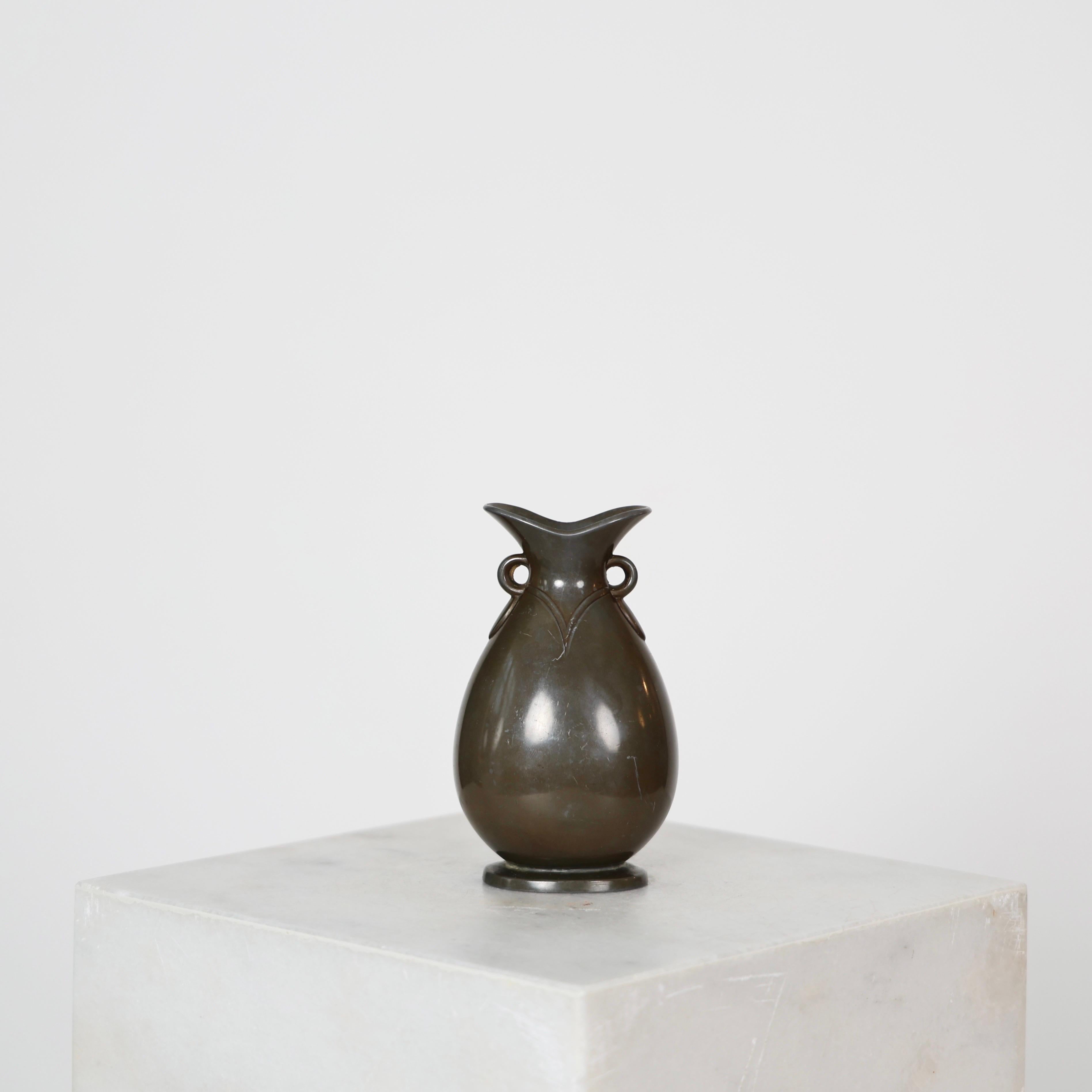 Art Deco Diskometal Vase designed by Just Andersen in the 1920s. 

* Drop-shaped diskometal vase
* Designer: Just Andersen
* Model: 1556 
* Year: 1918-1929
* Condition: Good vintage condition. Makers engraving intact. Few small marks and scratches. 