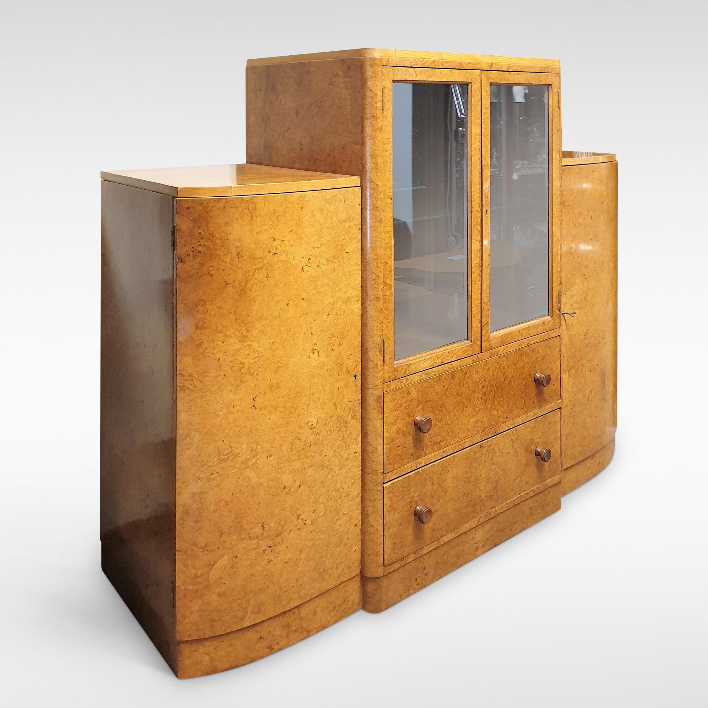 Art Deco display cabinet in burr walnut veneers. Mirrored interior, with drawers under and flanking cupboards, circa 1935-1955

Price includes full restoration using traditional techniques & materials. Please allow 6-8 weeks.