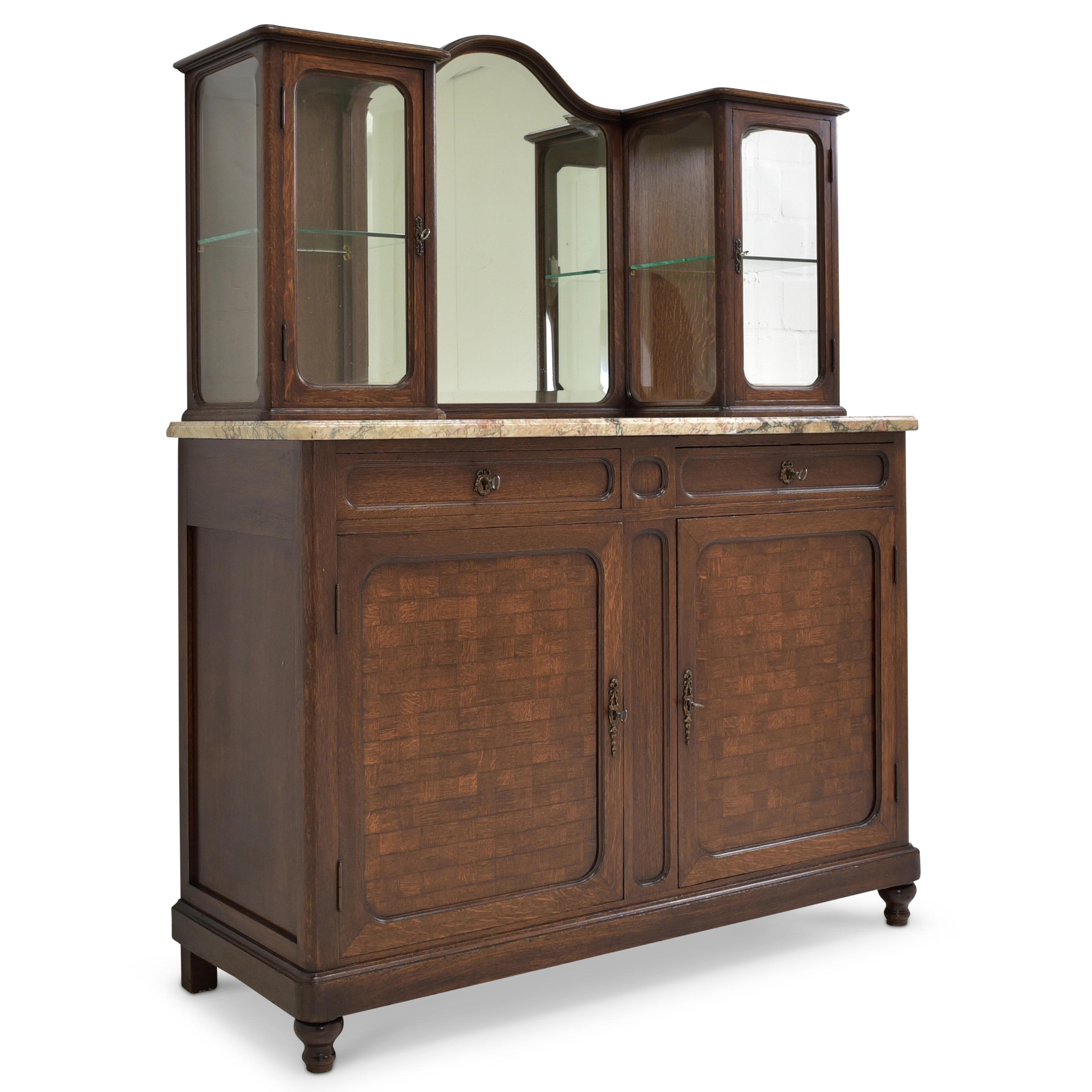 Display cabinet restored Art Deco around 1925 oak sideboard buffet

Features:
Two-door base with shelf and two drawers
Essay on marble slab with two vitrines and mirror
High quality
Drawers pronged
Original fittings
Seven-part glazing with
