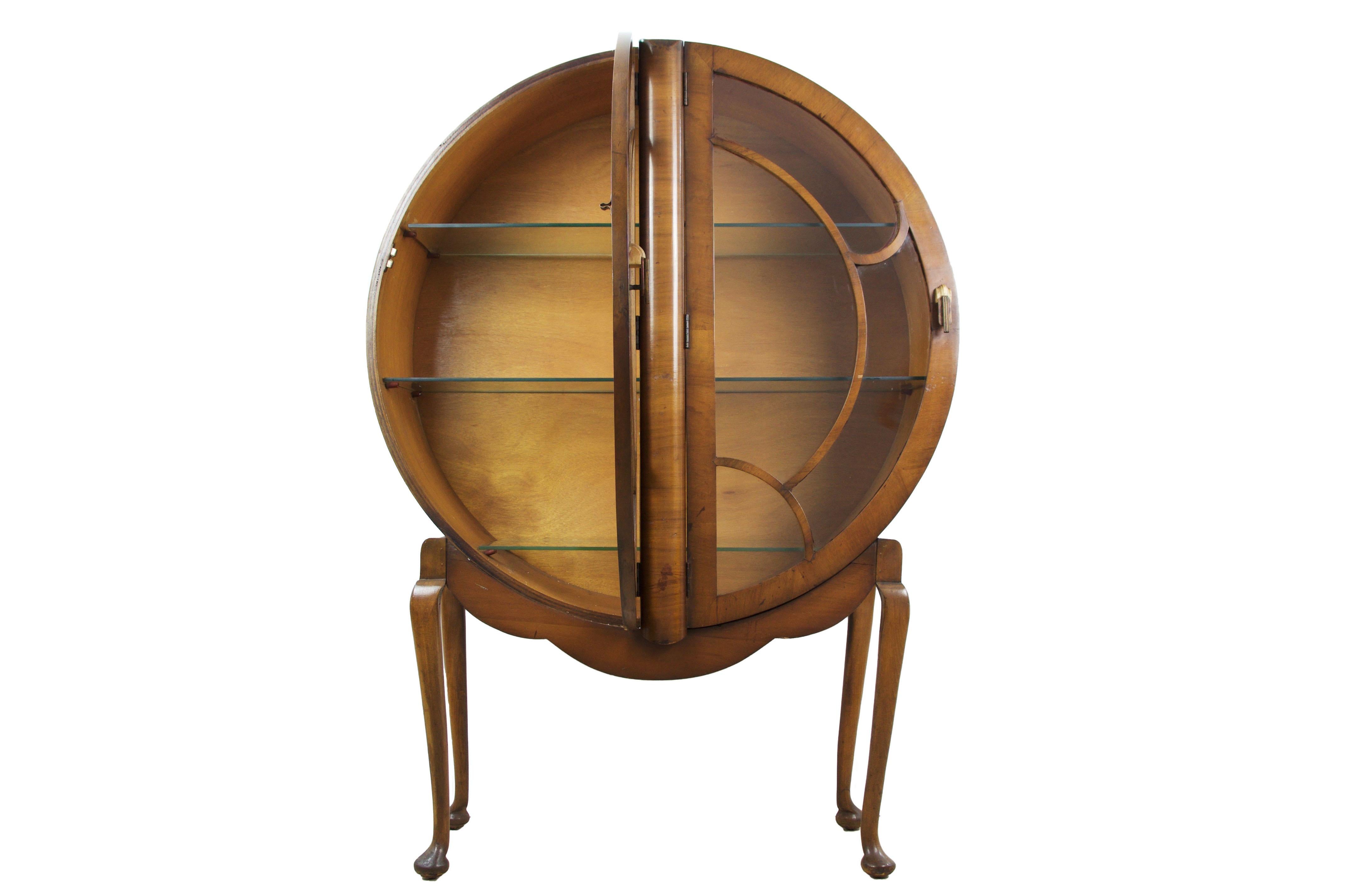 Art Deco display cabinet vitrine, English, circa 1930 in walnut. Round glazed cabinet on a shaped apron and cabriole legs. Piece has been fully restored and is in excellent condition.