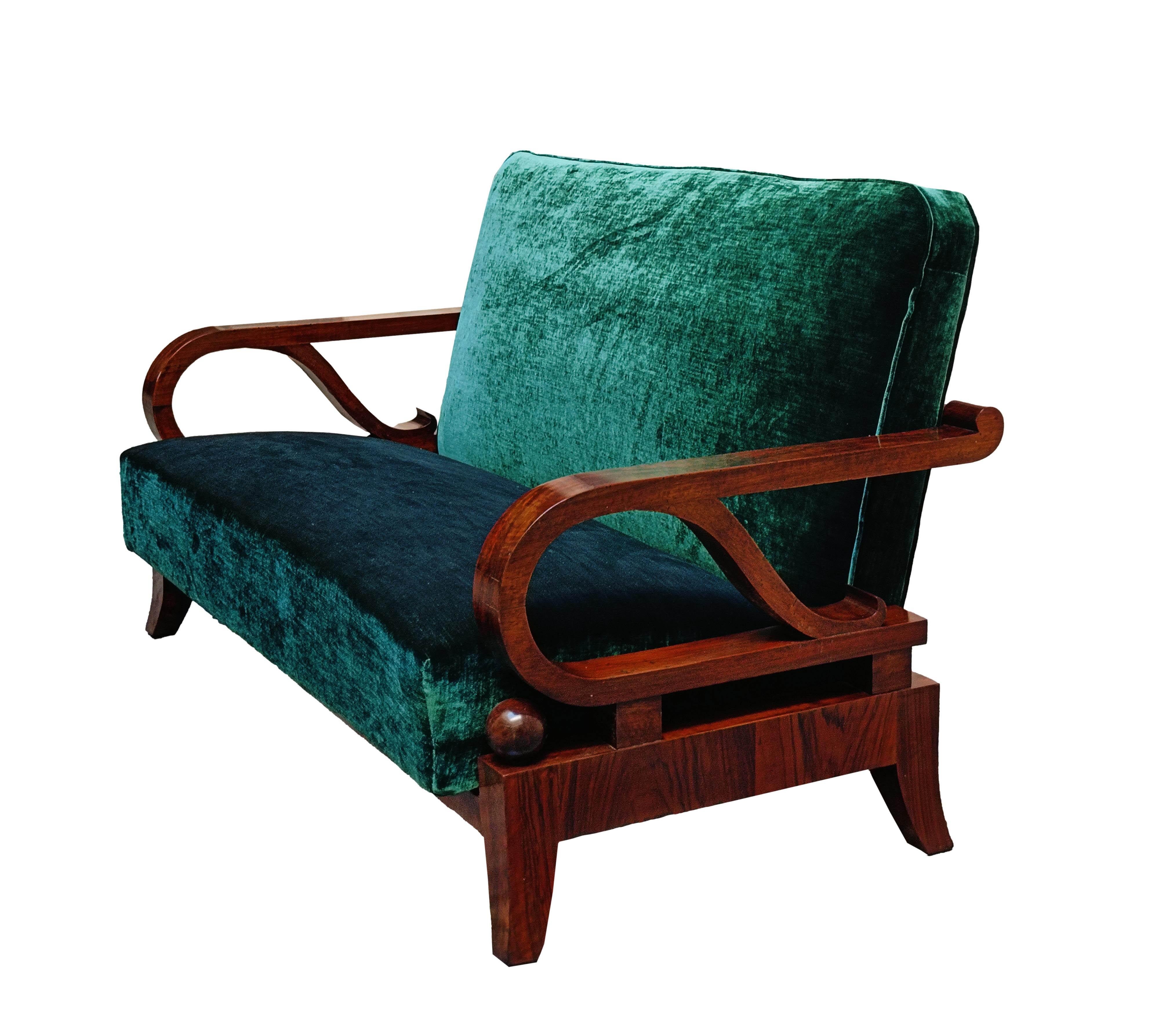 An elegant and unique timeless sofa  from the early Italian Art Deco period, made of walnut and green velvet upholstery. The rectangular backrest allows the sofa to be placed in the center of the room, and the armrests have a geometric, curved shape