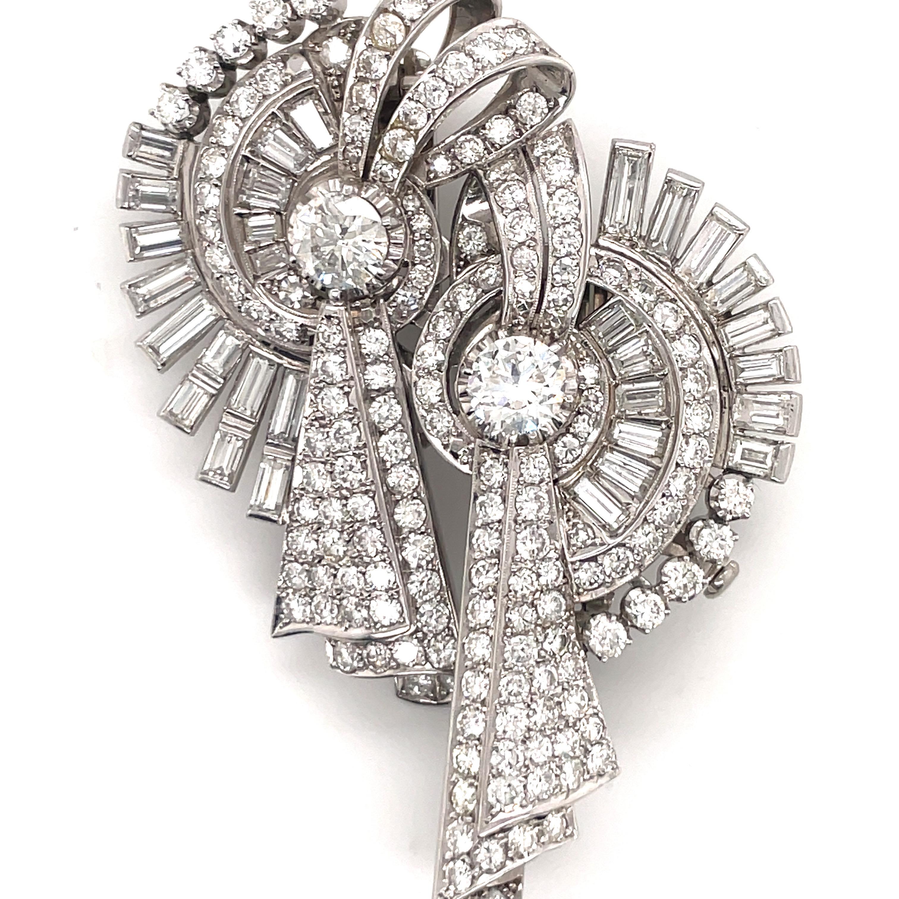 Circa 1920's this Art Deco double brooch features two center diamonds weighing approximately 2.20 carats total flanked with numerous diamonds weighing approximately 12 carats.
Can be worn together or as one. 