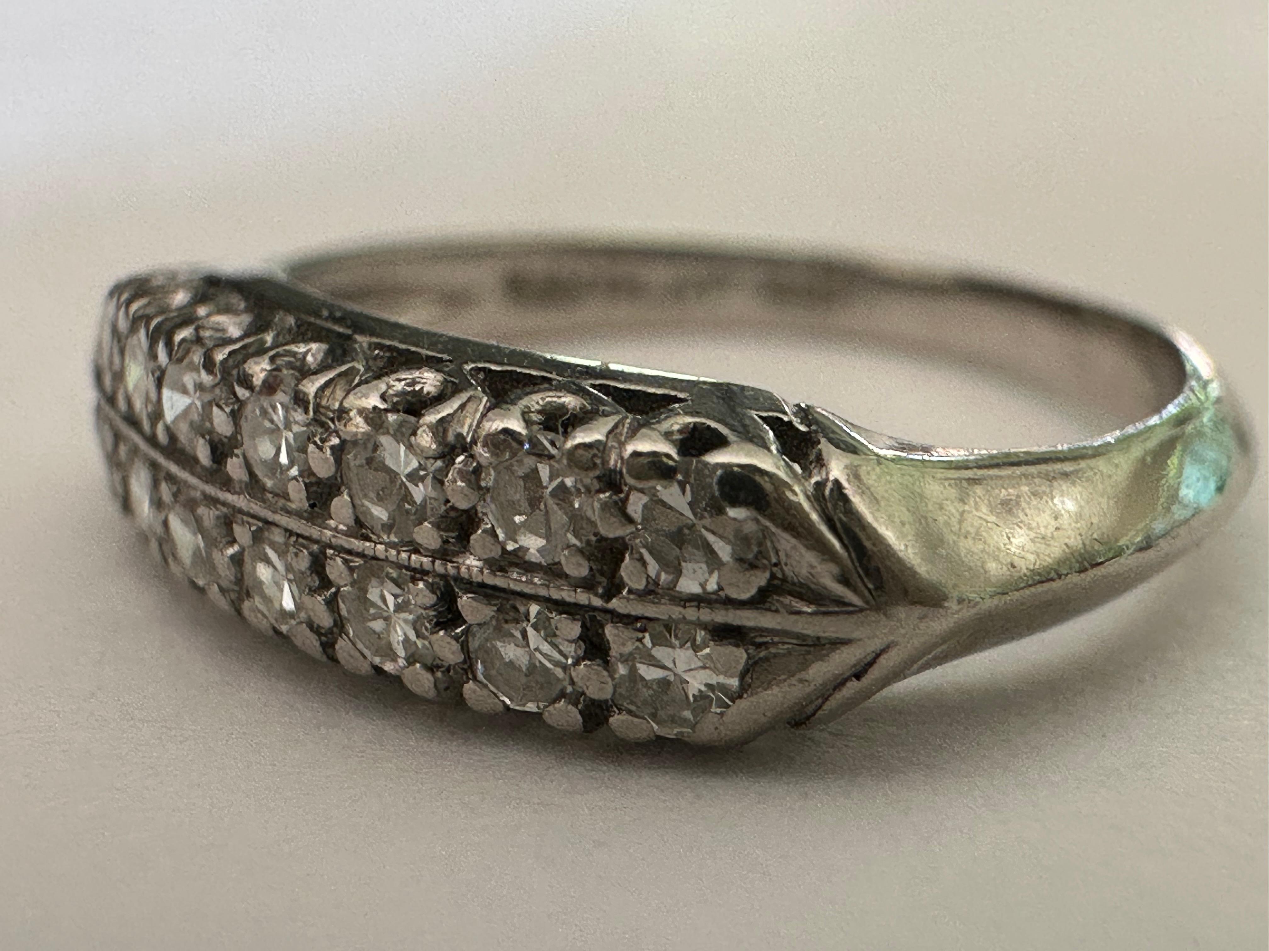 Parallel rows of fourteen glittering white single-cut diamonds totaling approximately 0.25 carats, F color VS clarity, set atop a lustrous platinum shank in this Art Deco gem. Currently size 3 (a perfect pinky ring), but can be resized. 


