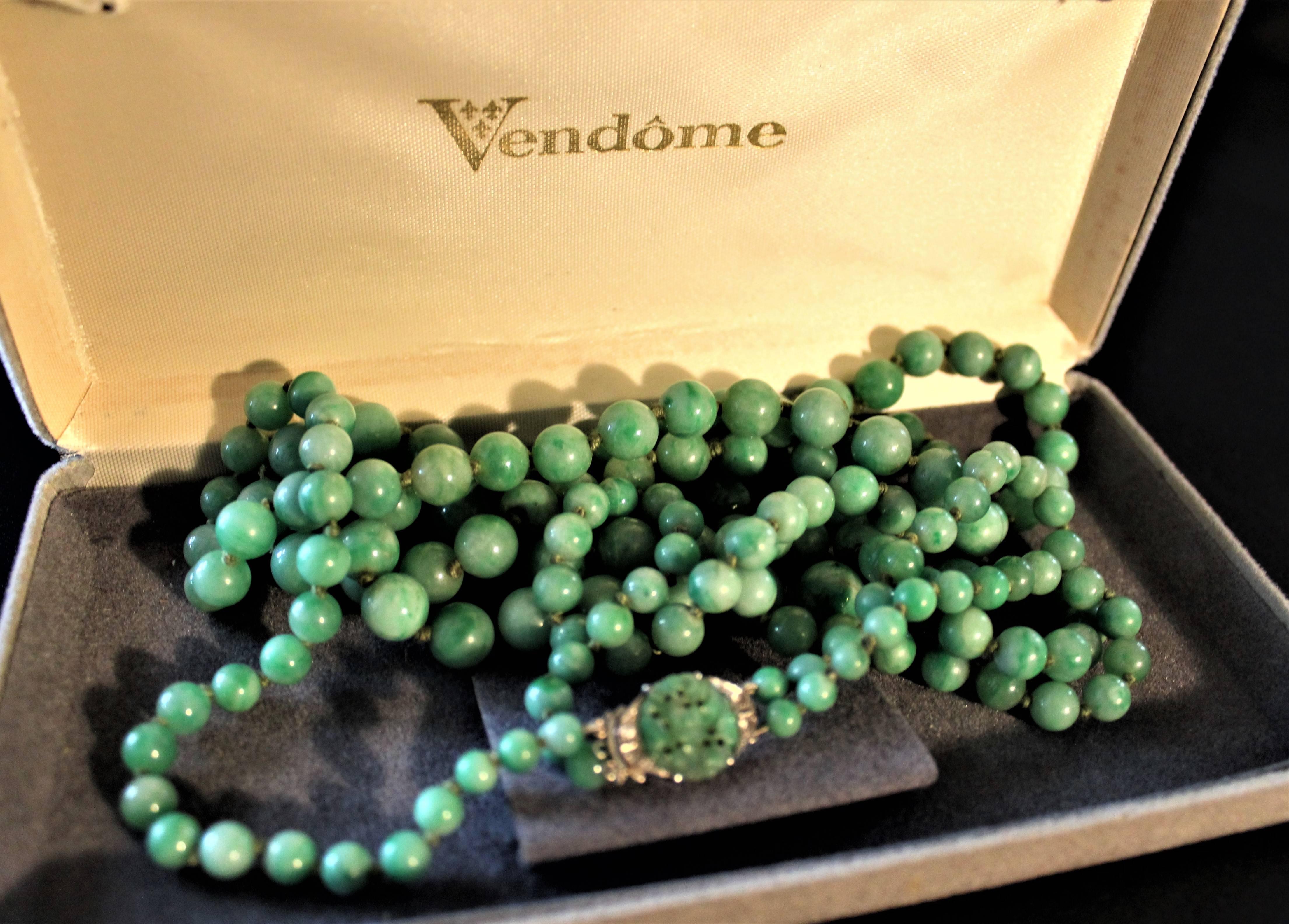 Art Deco double strand Jade hand strung graduated bead necklace with 18-karat gold, four diamonds and Jade on clasp. Measures: 27 inches long double strand, 14 inches tied.