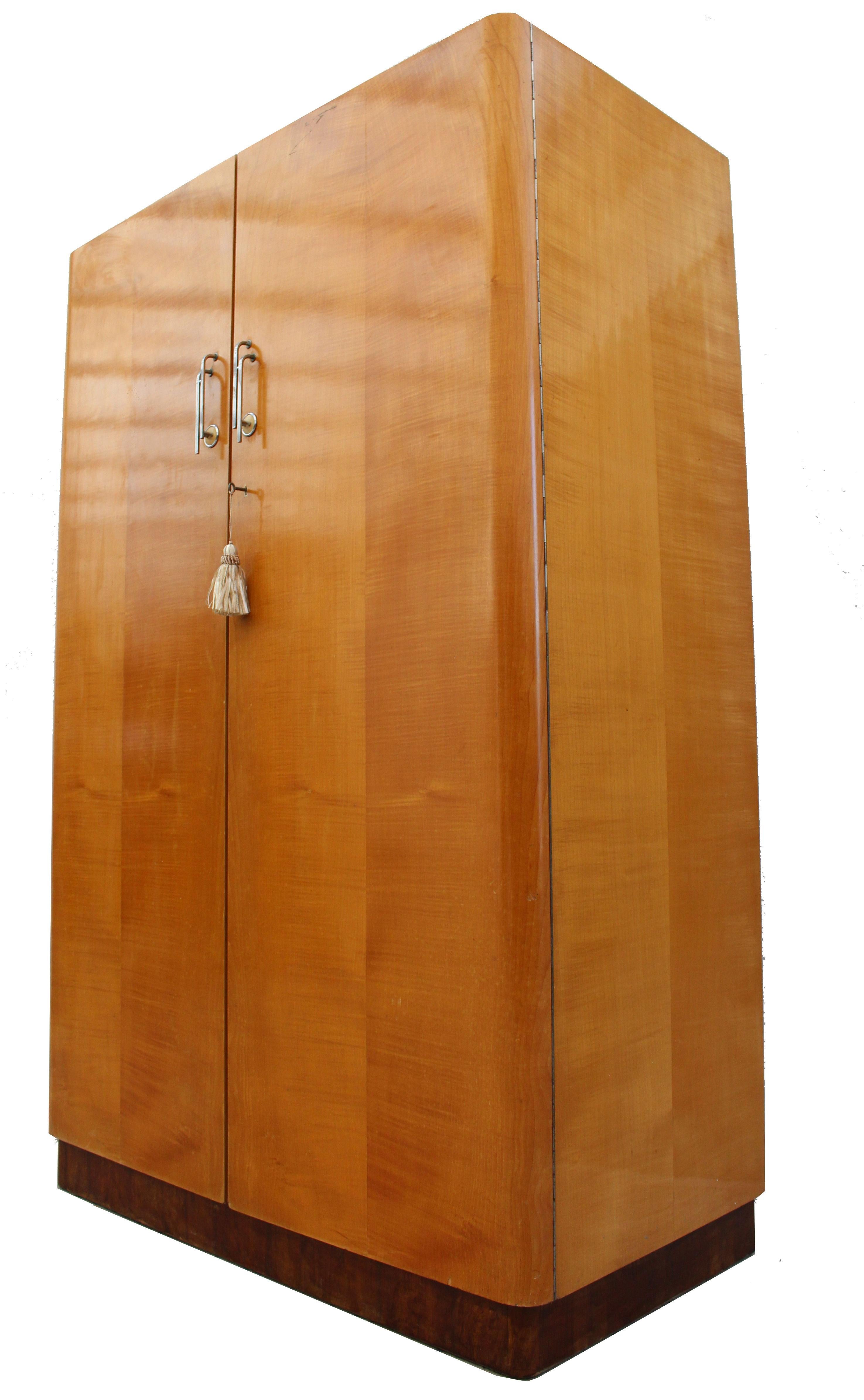 For your consideration is this beautifully styled original Art Deco double wardrobe, English and dating to the 1930s. Features round shouldered doors, all raised on a contrasting darker figured walnut veneered plinth. The doors are book paged and