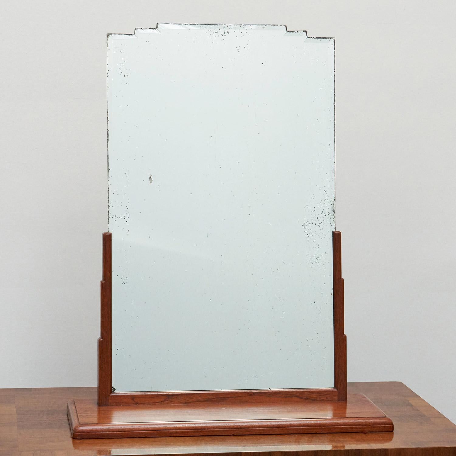 Art Deco Dressing Mirror by Betty Joel. Geometric shaped solid walnut frame with the mirror in good condition also with shaped top. 

Dimensions: H 79cm W 63cm D 22cm 

Origin: English

Date: Circa 1930

Item Number: 902227

Betty Joel was