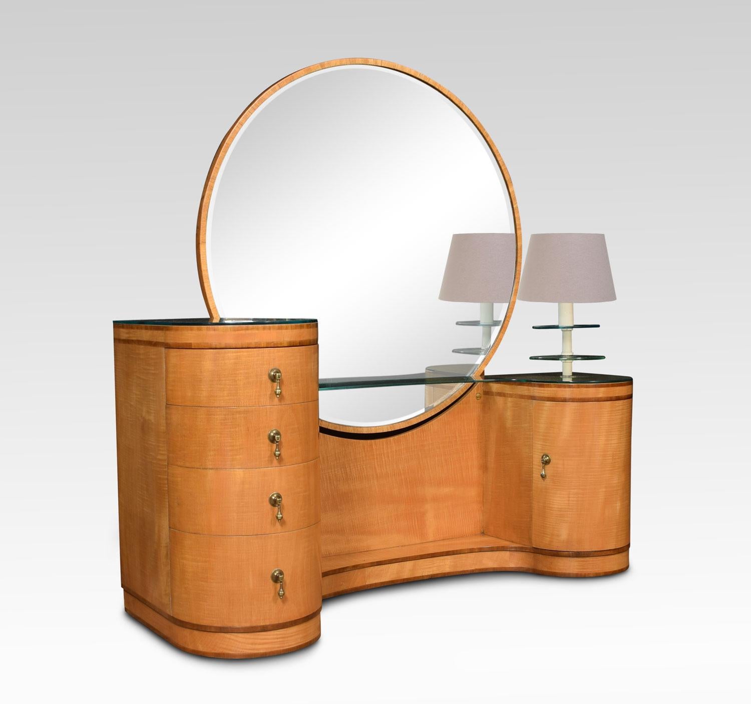 Art Deco maple and walnut banded dressing table with round beveled mirror and a curved inverted plinth, flanked by twin, bow front pedestals, one containing four graduated drawers and the other a curved door, surmounted by a glass shelf and light