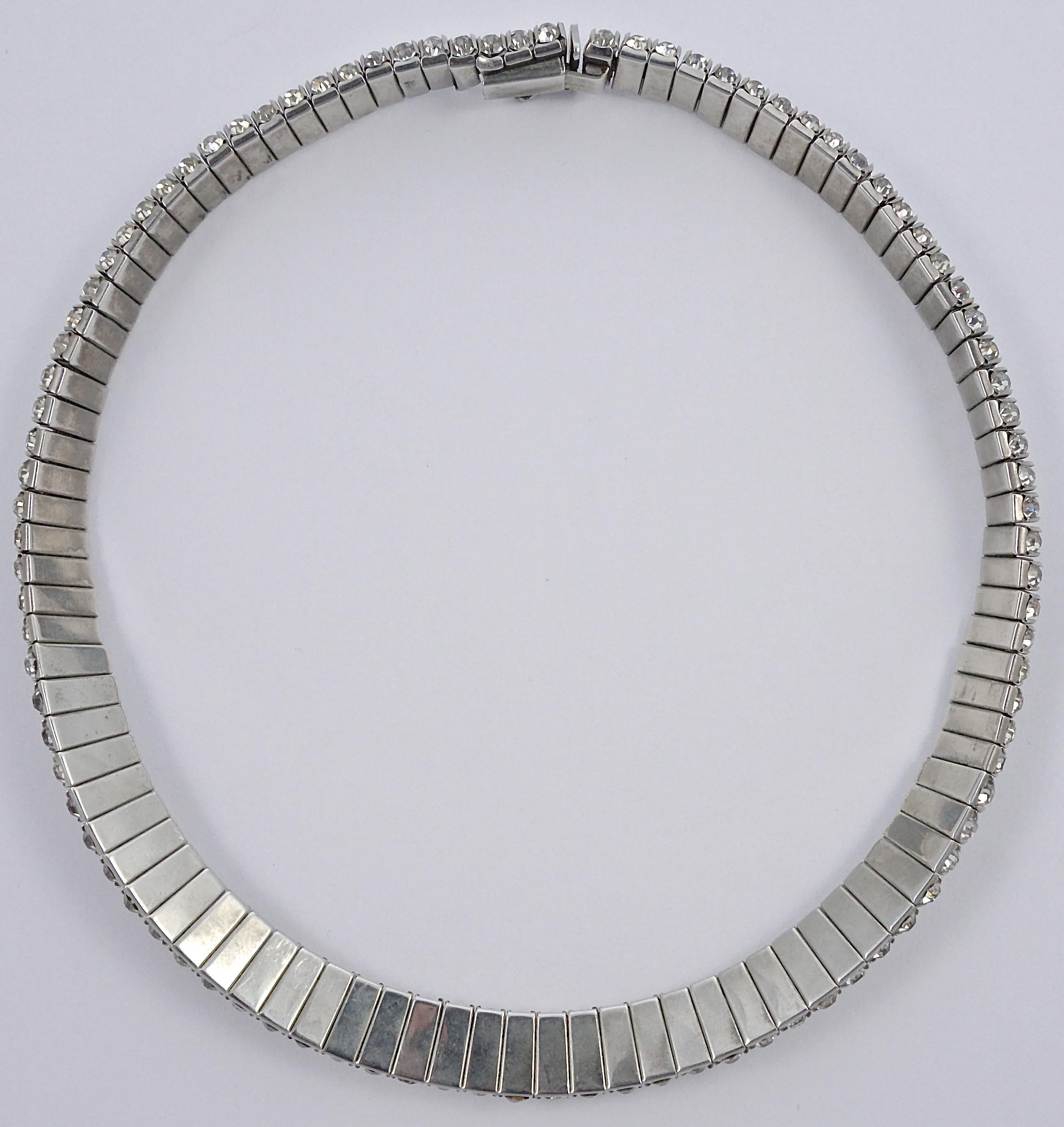 Stylish DRGM Art Deco silver tone necklace featuring channel set rhinestones. There are four sparkling rhinestones making up each link. Length 39.5cm / 15.55 inches by width 1cm / .39 inch. The clasp works well and has a safety catch. This fabulous