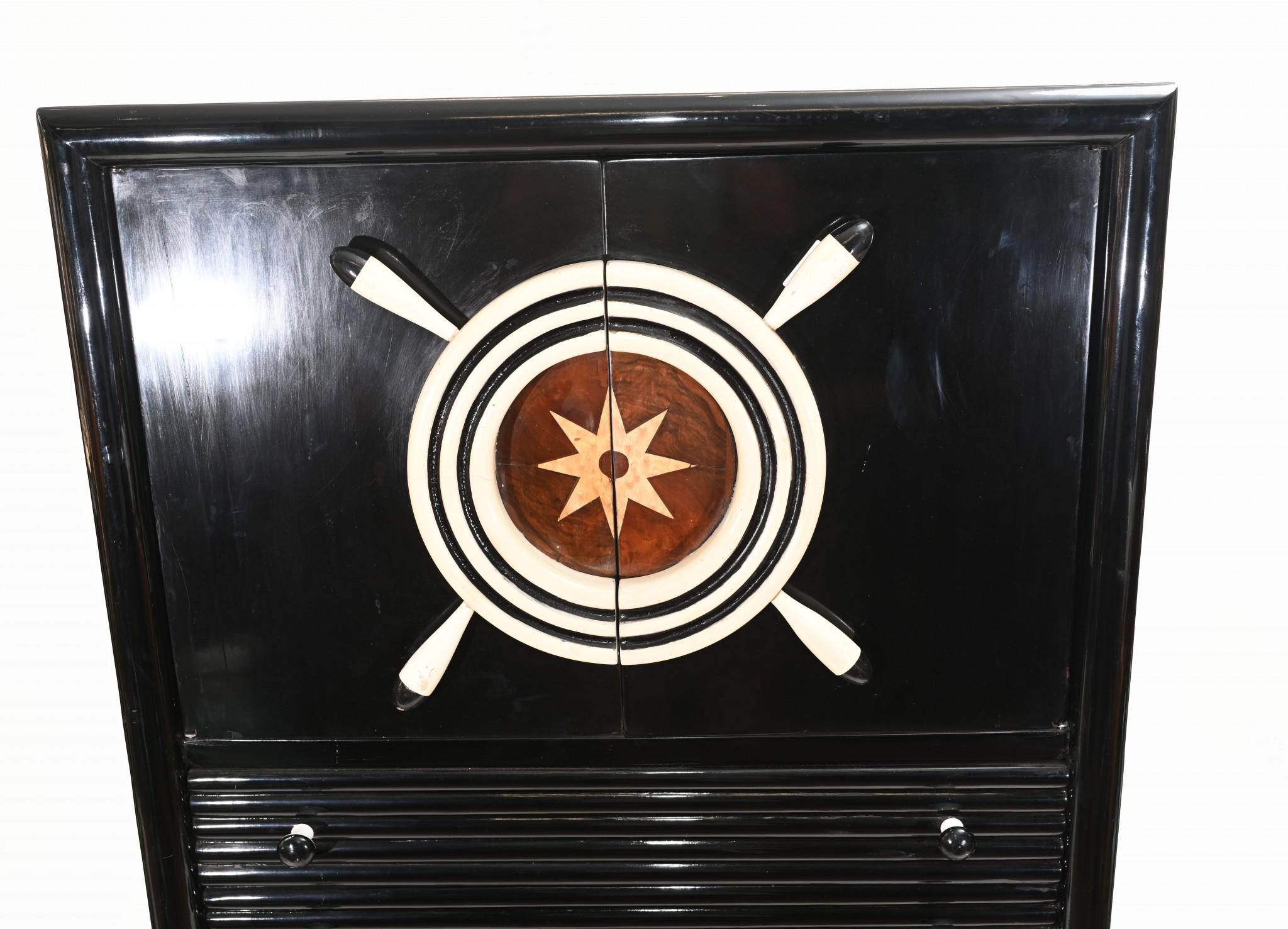 Wonderful Art Deco style drinks cabinet with a lacquer finish
Love the nautical theme to the design with ships stearing wheel cabinet door handles
Black trim offset by lighter shade of cabinet
Very unique interiors look, great for beach or