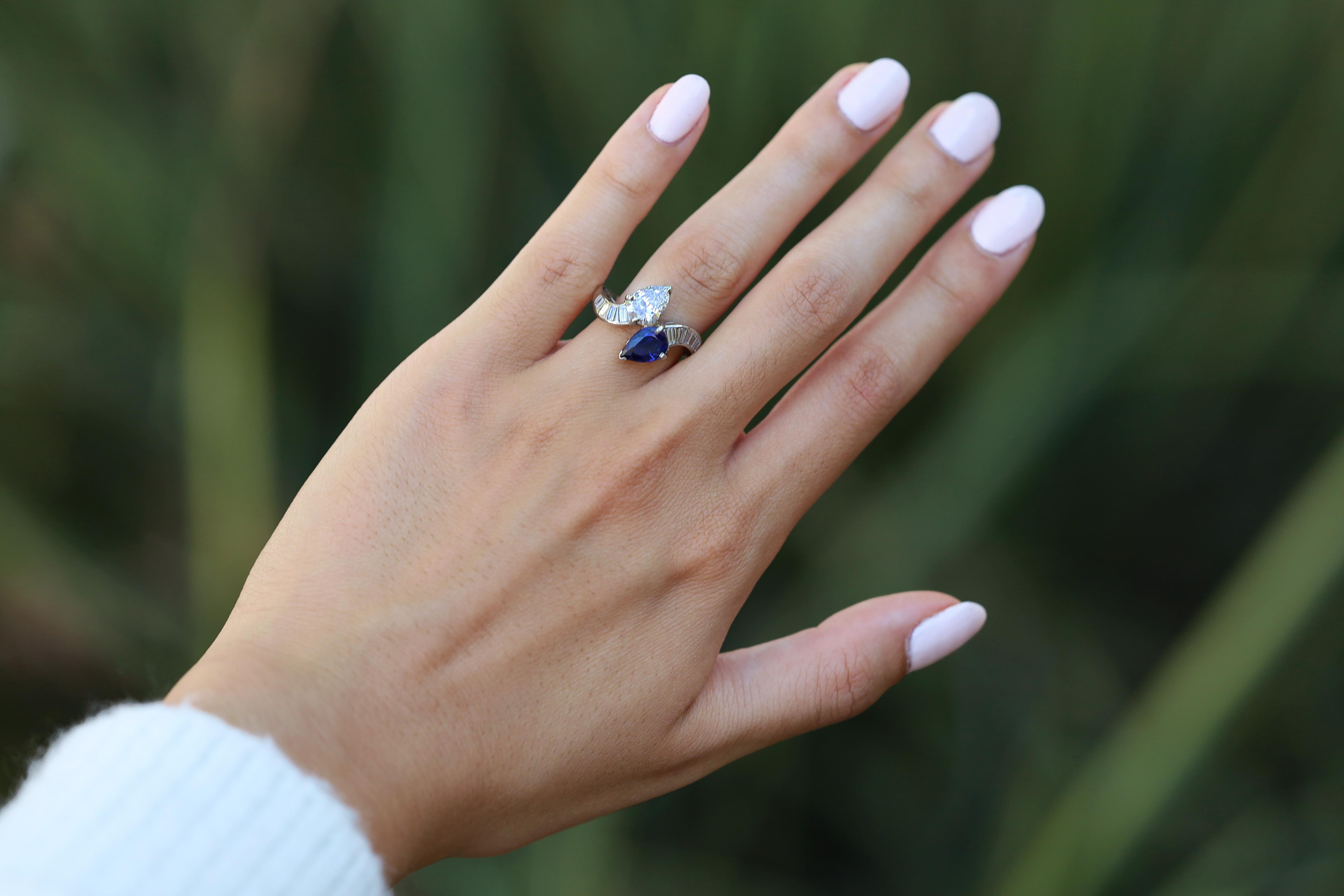 An absolutely embraceable 1920's Jazz Age diamond and sapphire Toi Et Moi ring. Featuring the sleek, geometric architecture you would expect from an Art Deco masterpiece, along with a GIA pedigree on the central pear shape diamond. Totaling 2.88