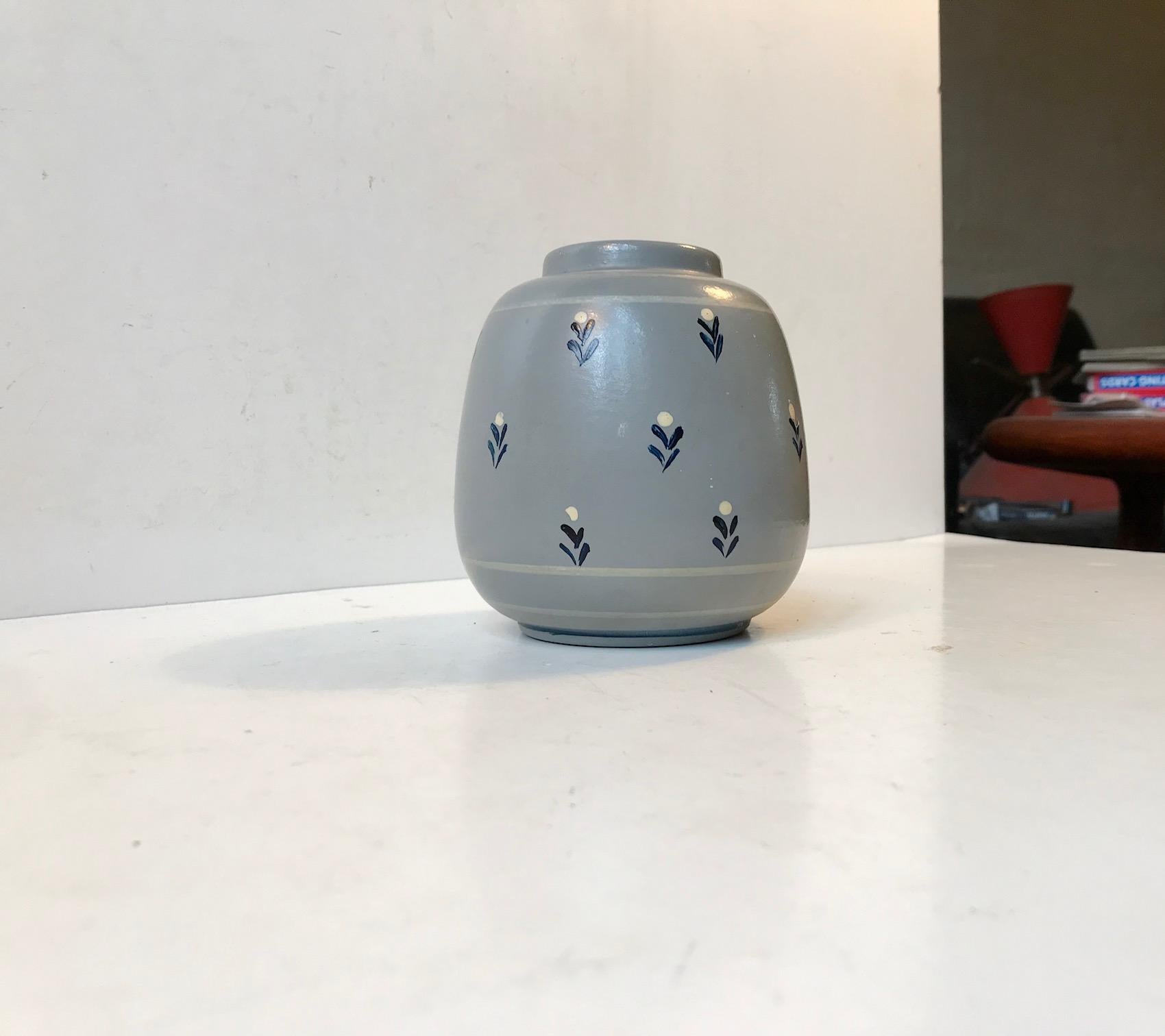 Small grenade shaped earthenware vase with elefant grey main paint and hand decorated with small flowers. It was made by Knabstrup in Denmark during the 1920s or 1930s in a style derived from French and German Art Deco era pottery.