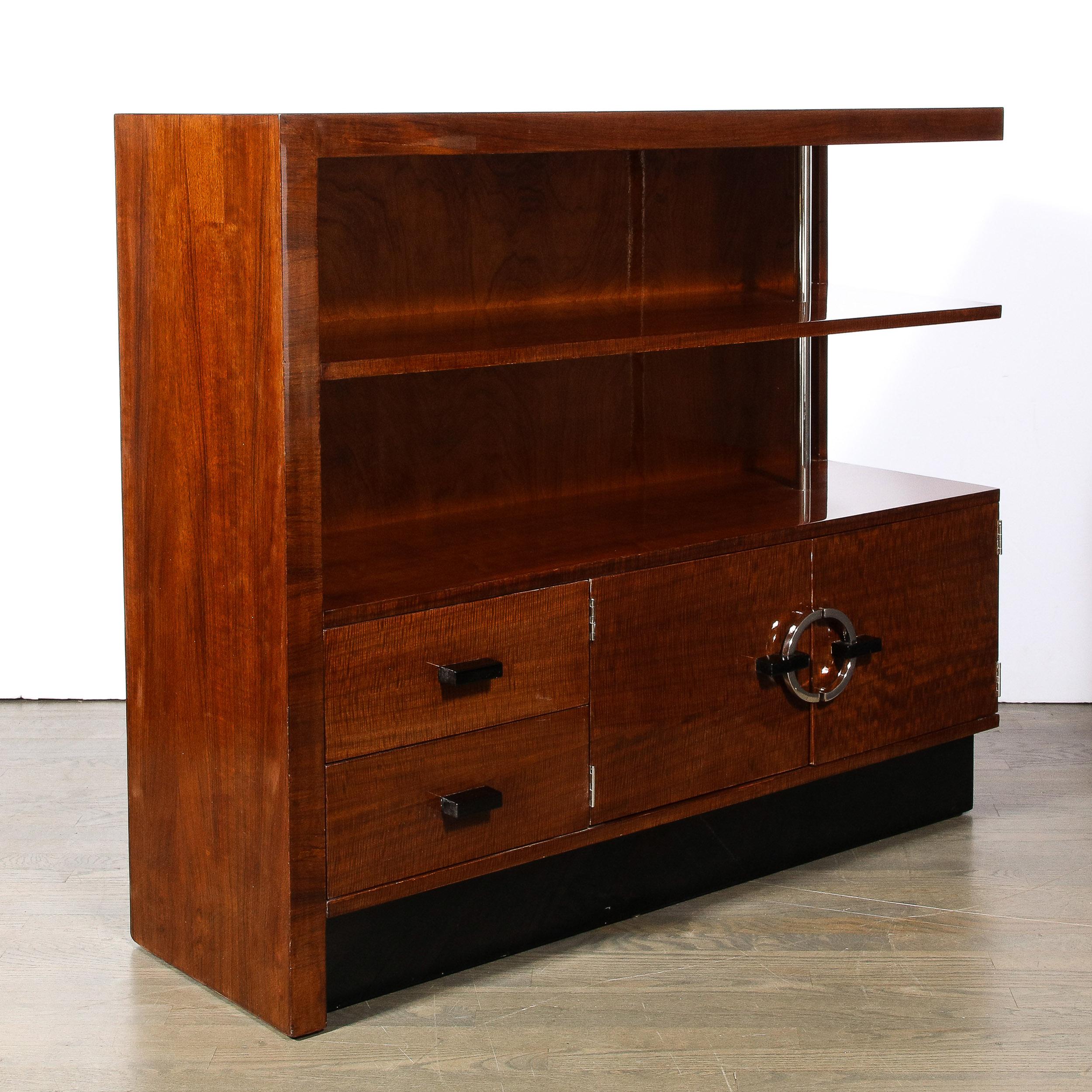 This well composed and materially stunning Art Deco Bookcase/Cabinet by Gilbert Rohde in East Indian Laurel for the Herman Miller Company- Model No. 344 originates from the United States, Circa 1940. . Composed in a distinctive cut of East Indian