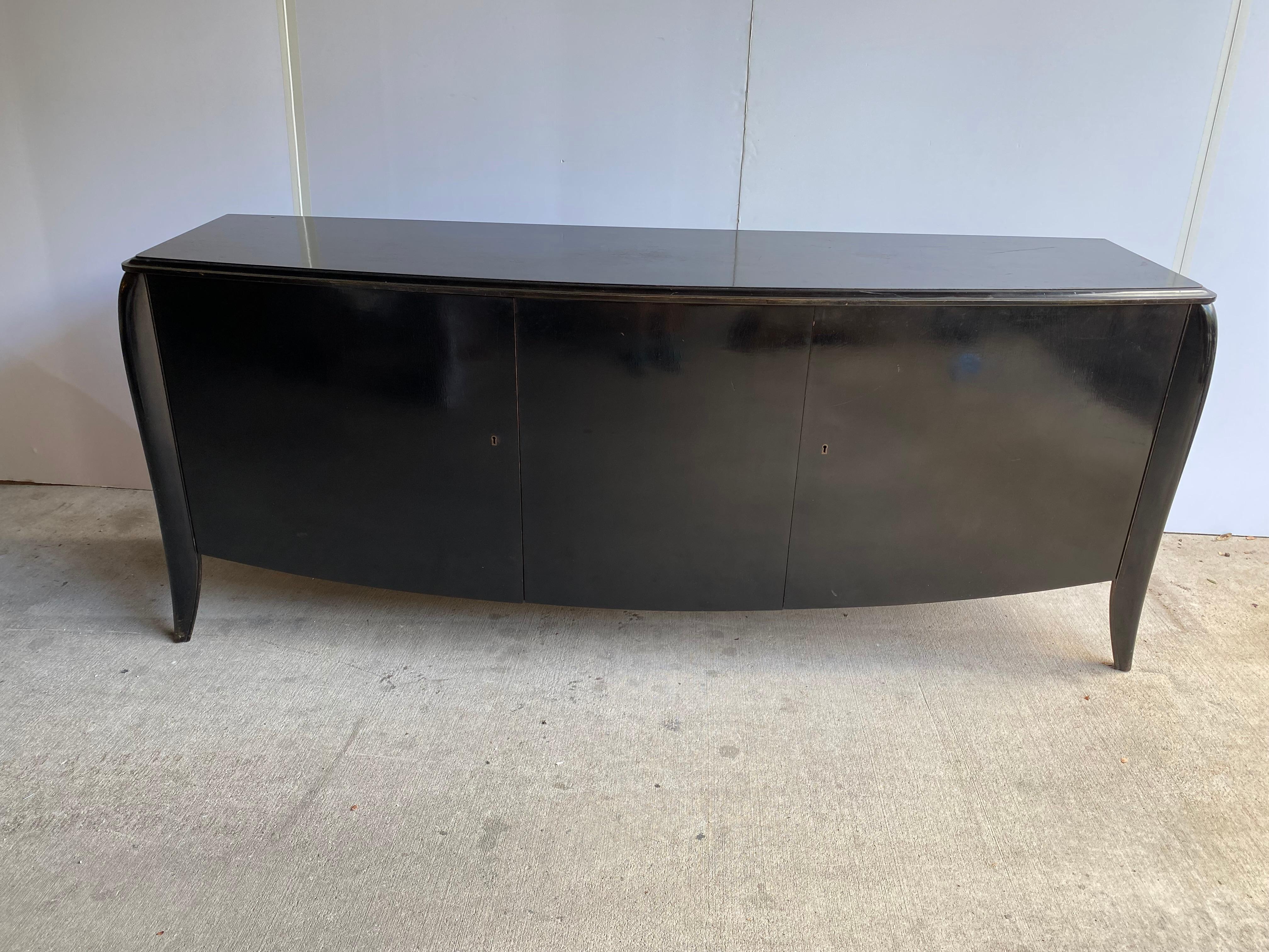 Ebonized mahogany sideboard with well-fitted interior storage. Art Deco styling by De Coene Freres, from their early work. The black ebony finish has great depth and luster that is difficult to capture in the photographs. The simplicity of the