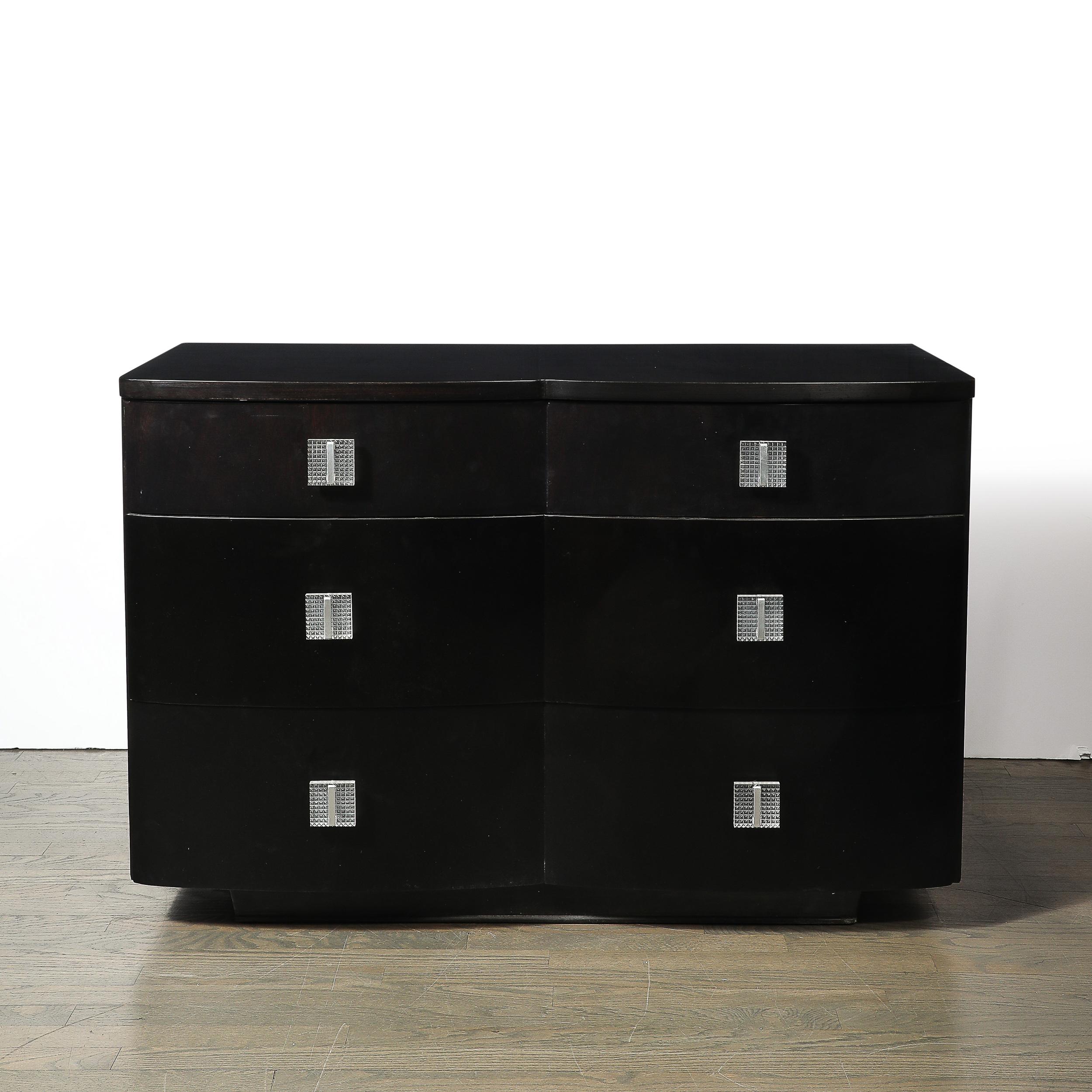Introduce the sleek sophistication of the Art Deco era into your home with this Ebonized Walnut Low Chest, featuring molded Lucite pulls. Crafted in America circa 1940, this piece exemplifies the streamlined elegance and modern design principles
