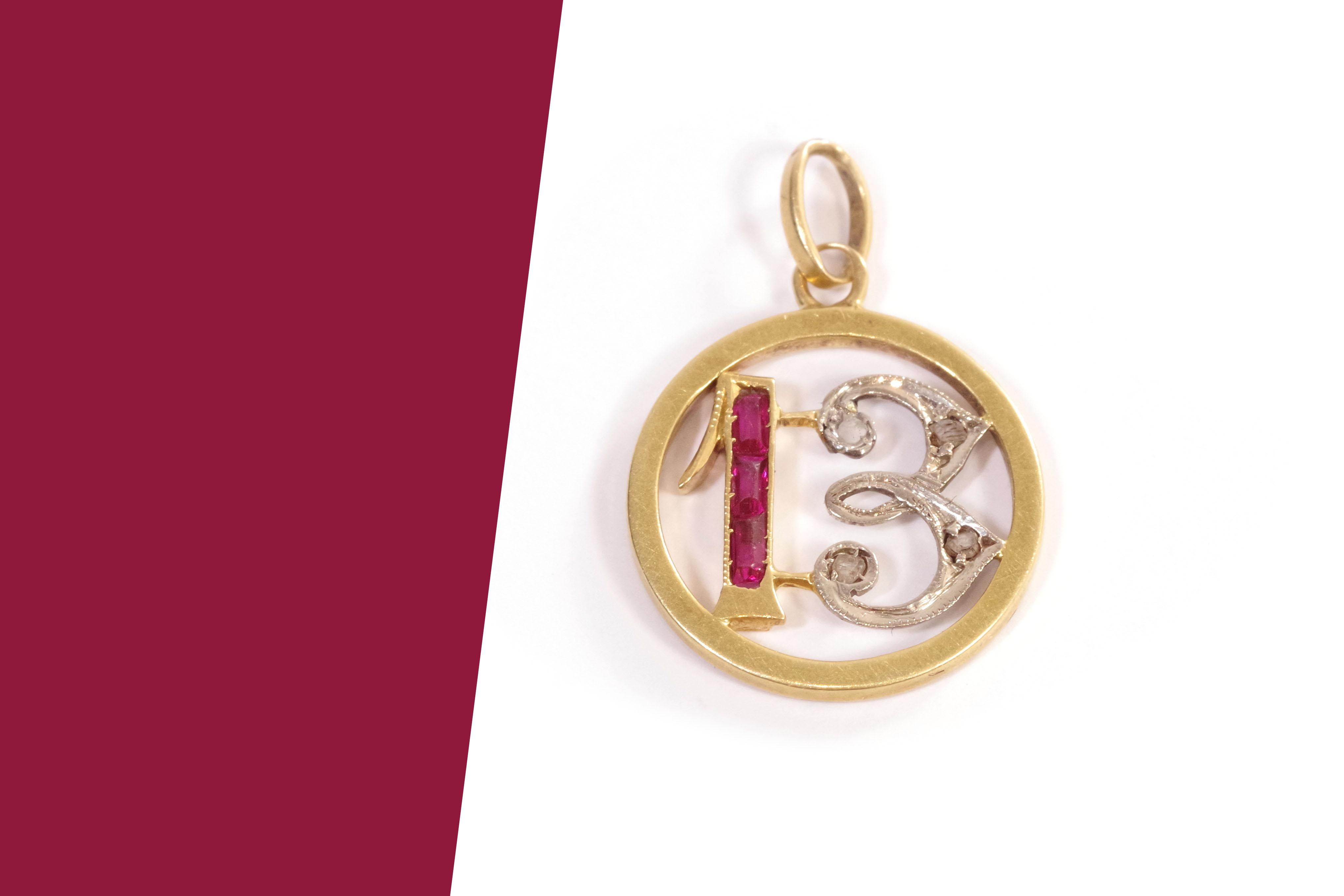 Art Deco Edwardian pendant 13 in 18-karat rose gold and platinum. Lucky charm pendant featuring the number 13 at its center, set with 3 synthetic rubies and 4 rose-cut diamonds. These small lucky charm medallions were fashionable in the early 20th