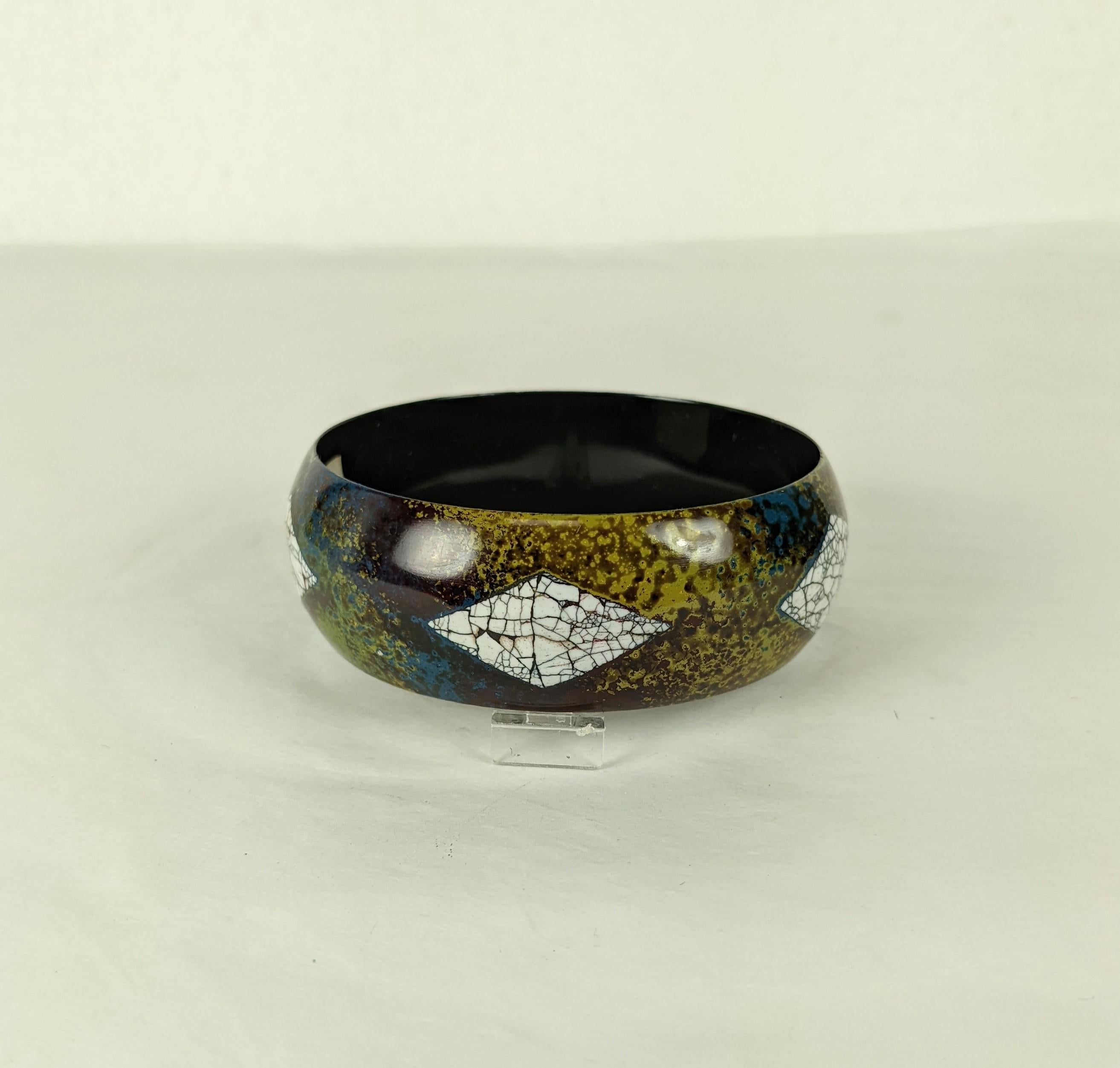 Art Deco Eggshell Lacquer Bangle Bracelet. The round and bombe bracelet decorated with five diamond shapes of crackled eggshell lacquer. The bangles background of mottled, stippled earth tones in lacquer. Excellent Condition, Made in France.