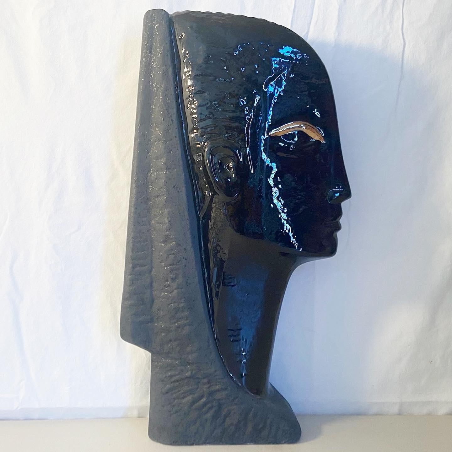 Amazing ceramic sculpture of Egyptian head. Features a black gloss with gold accent.
 