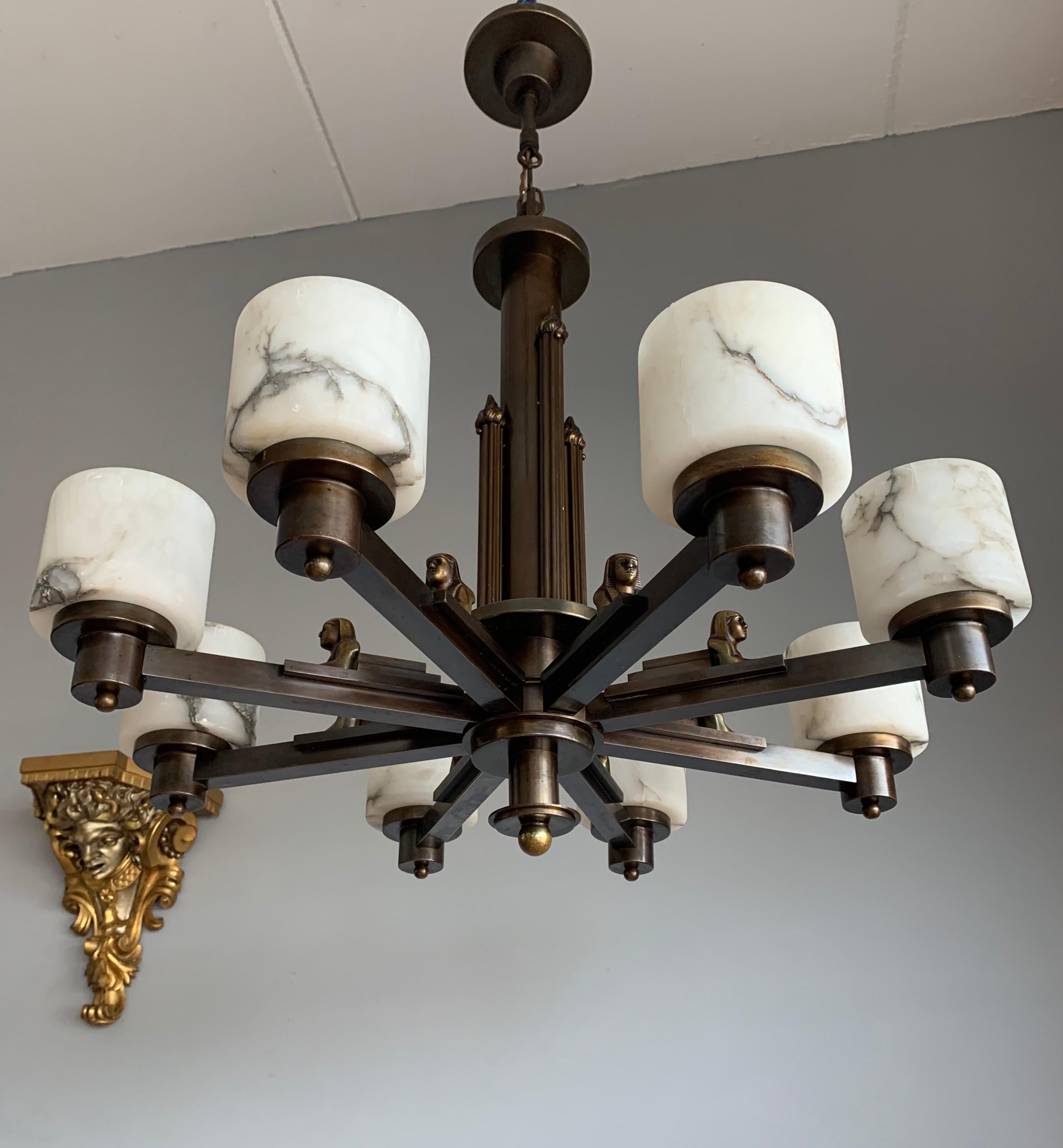 Stunning Art Deco eight-light pendant with bronze sphinx sculptures.

If you are looking for a one of a kind and truly striking antique pendant to light up both your days and evenings then this Egyptian Revival work of lighting art could be yours to