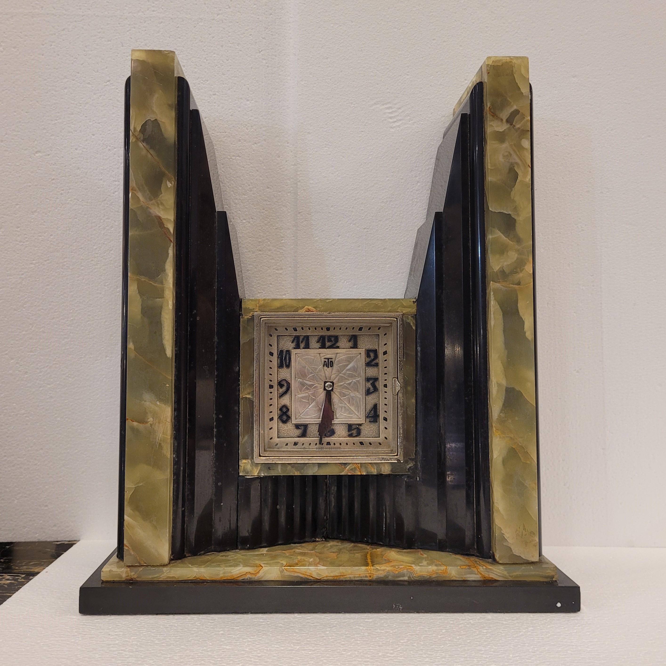 Amazing Art Deco Egyptian  French  Mantel  clock by the electric clock manufacturer ATO of Besançon, France. Emerald Onix from Brasil over black Belgian marble body with square chromed bezel and highly stylized face. Stunning combinationof green and