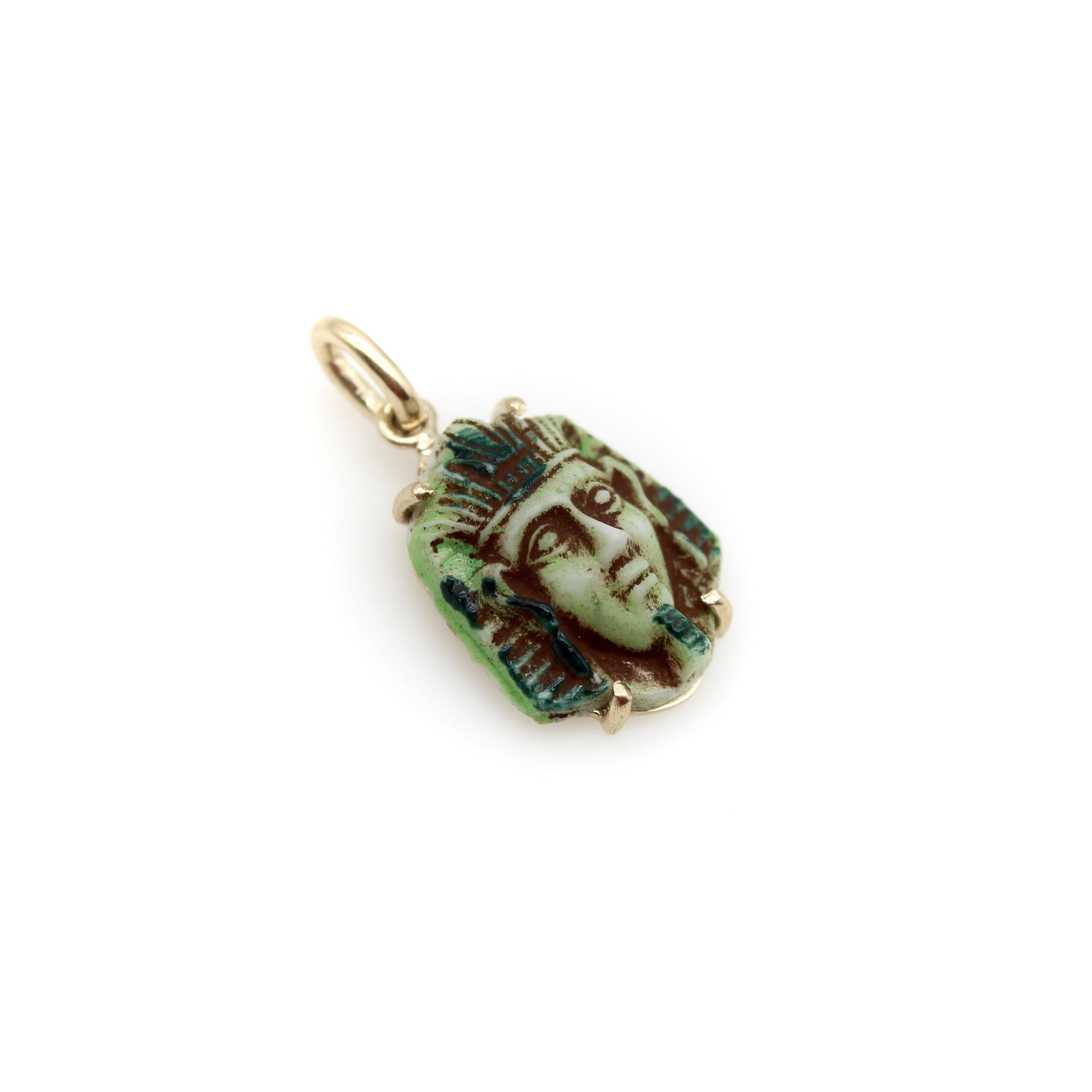 This beautifully sculpted Pharaoh face plaque is from the 1920's. It is a faience piece with turquoise glaze that ranges in blue and green hues. Kirsten's Corner procured a handful of these pieces and we have added the 14k gold mount. The gold back