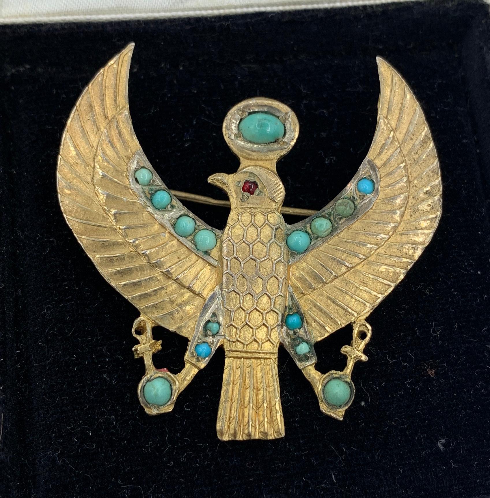This is a very rare antique Art Deco Egyptian Revival Horus Falcon Bird Pendant Necklace or Brooch in Silver Gilt with Turquoise cabochons.  The image of Horus is based on an amulet belonging to King Tutankhamun.  The wonderful Horus Pendant is