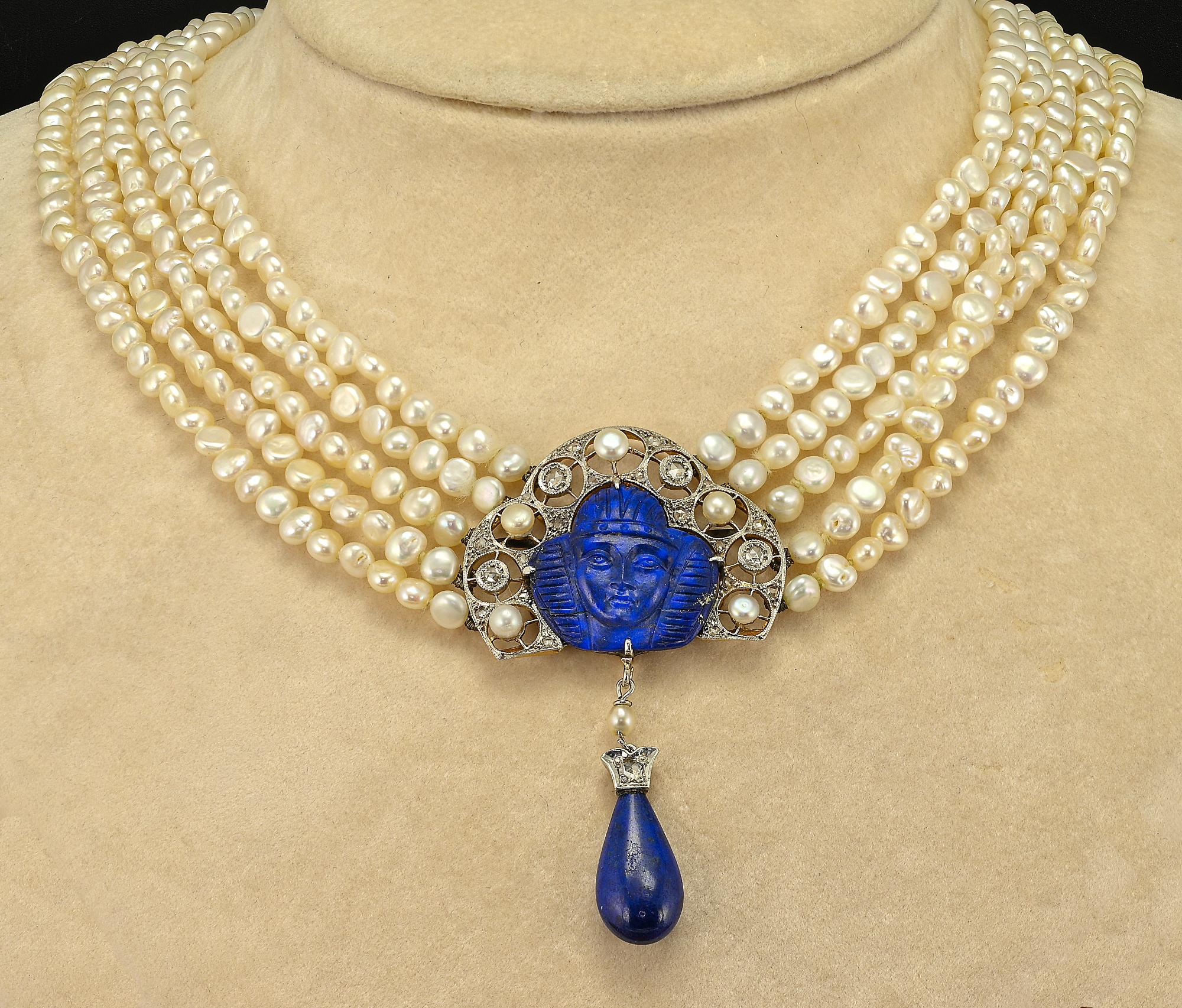 Unique Art Deco Egyptian Revival necklace, 1920 circa

Comprising a skillfully natural Lapis hand carved centerpiece featuring an Egyptian Pharaoh, magnificent open work made of solid 18 KT gold platinum topped adorned with natural Pearls and rose