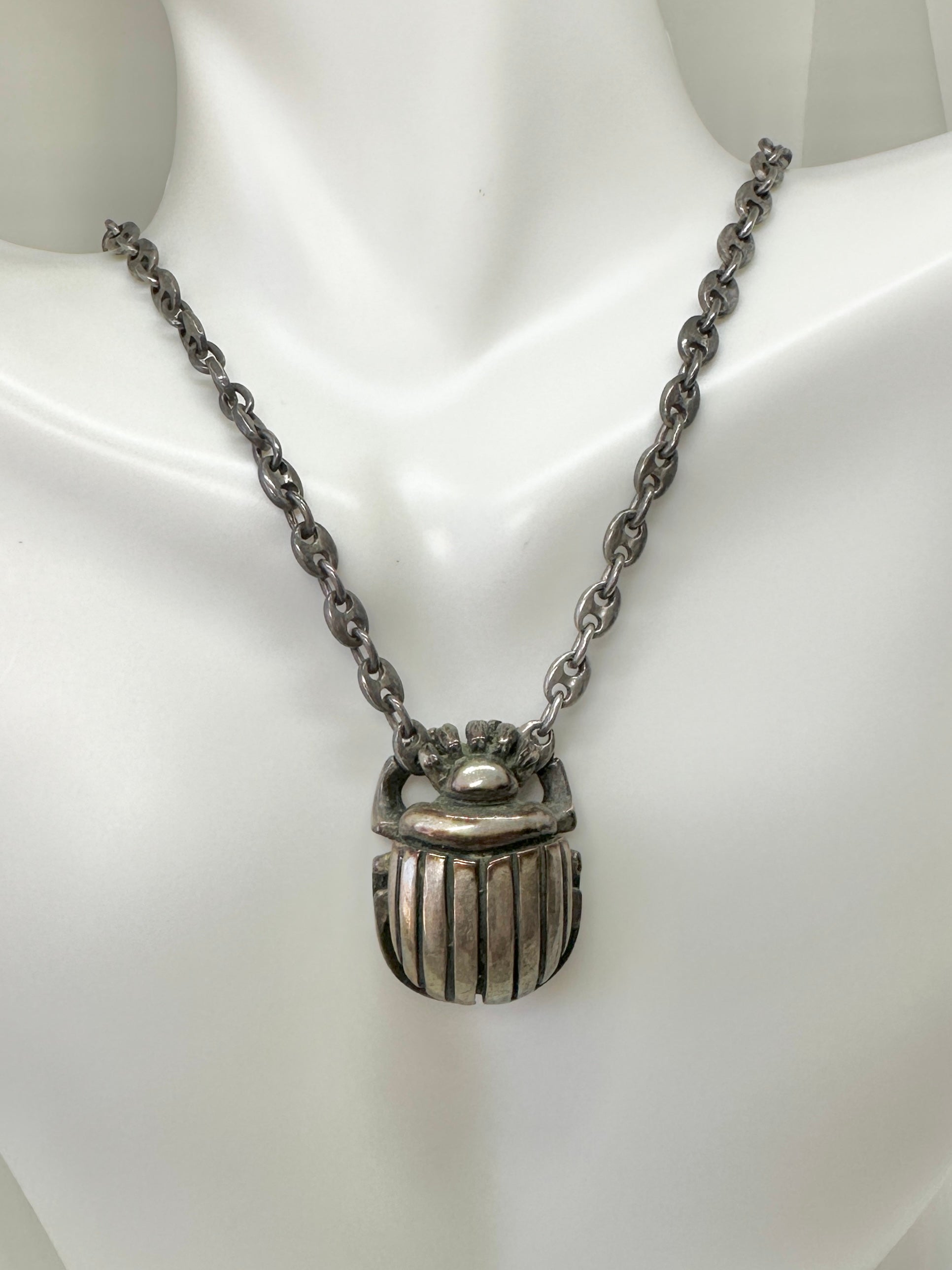 This is a very rare antique Art Deco Egyptian Revival Scarab Pendant Necklace in Sterling Silver with a stunning Link Chain.  The necklace is hallmarked Sterling JAR or JAD. The necklace is a heavy sterling silver and the substantial Scarab pendant